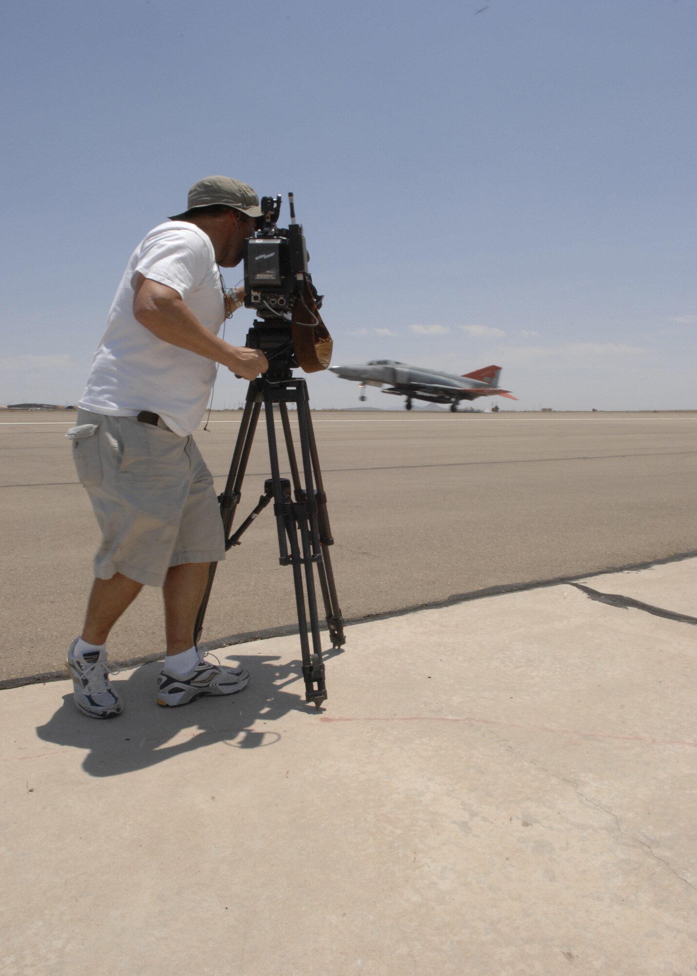 Mr. Mark Foerster, Canadian Discovery channel cameraman, documents the QF-4 drone landing and how it is operated remotely for a documentary to air on the Discovery Channel Canada's "Daily Planet" show June 24 on the flight line at Holloman Air Force Base, N.M. "Daily Planet" does not air in the United Stated, but it can be seen on Discovery Canada's Web site. (U.S. Air Force photo/Airman 1st Class Rachel A. Kocin)