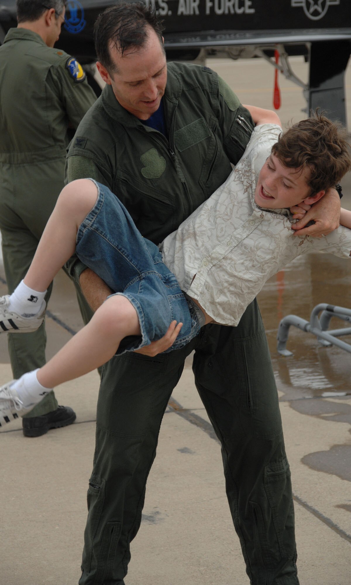 Colonel John K. Forsythe plays with his son at Holloman Air Force Base, N.M., June 27, after his fini flight. Colonel Forsythe's family was present for his last flight at Holloman.(U.S. Air Force photo/Airman 1st Class Jamal Sutter)