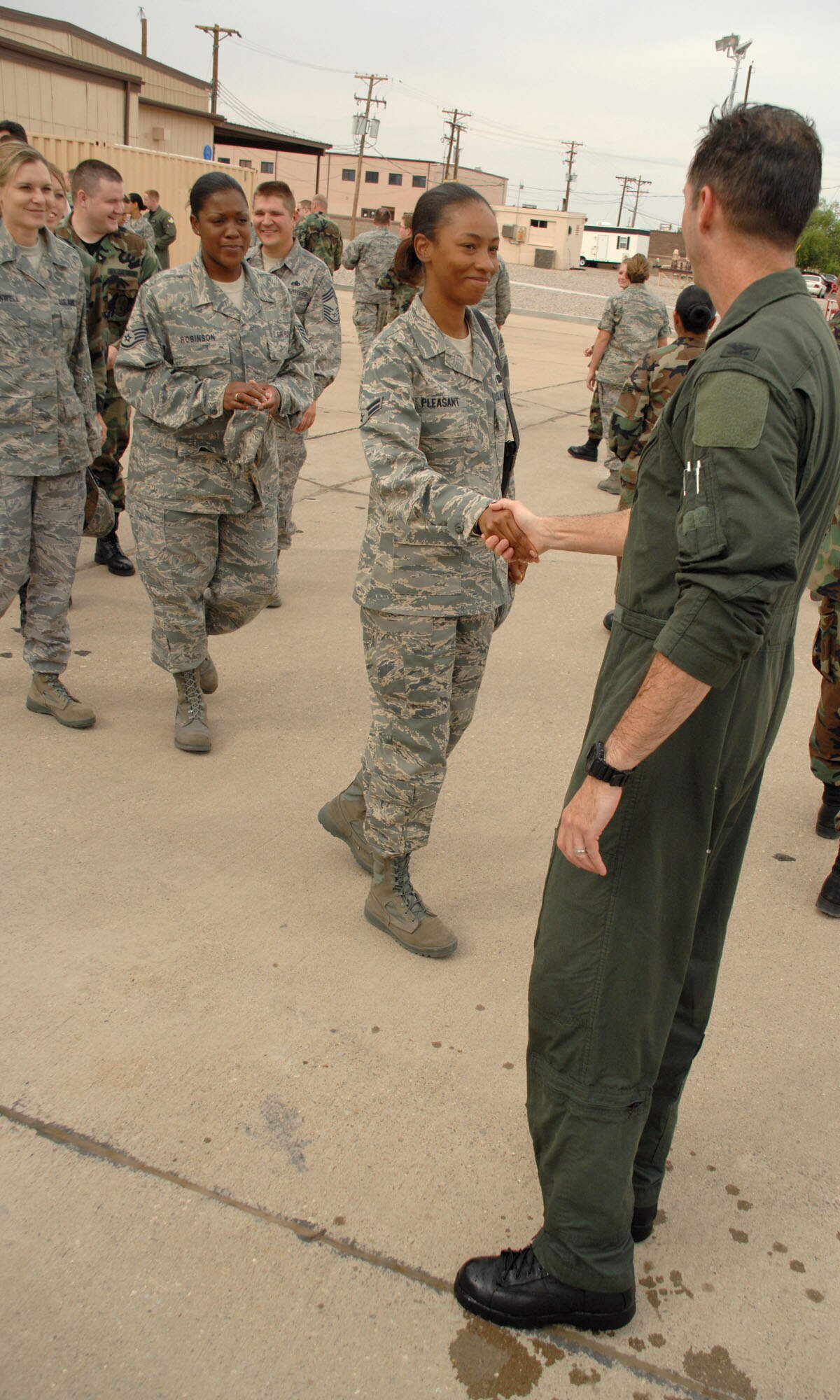 Col. John K. Forsythe, 49th Operations Group commander, shakes hands with Airman 1st Class Jessica Pleasent, 49th OG, at Holloman Air Force Base, N.M., June 27. The group was present for Colonel Forsythe's last flight at Holloman.(U.S. Air Force photo/Airman 1st Class Jamal Sutter)