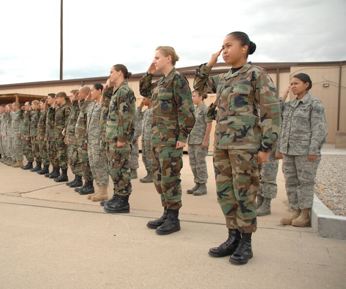 Members of the 49th Operations Group at Holloman Air Force Base, N.M., salute Col. John K. Forsythe as he departs for his fini flight on June 27. This is the last flight he will complete at Holloman.(U.S. Air Force photo/Airman 1st Class Jamal Sutter)