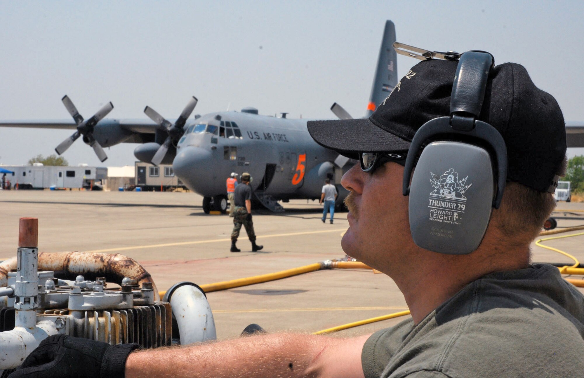 Michael Docklam watches as ground crews refill a C-130 Hercules with fire retardant prior to a firefighting mission June 29 at McClellan Airfield, Sacramento, Calif. Mr. Docklam is an aircraft structural repair specialist assigned to the 302nd Air Expeditionary Group. The 302nd AEG, responsible for eight aircraft, is currently fighting the Corral and Piute fires, each about 200 miles north and south of the California capital. (U.S. Air Force photo/Senior Airman Stephen Collier) 
