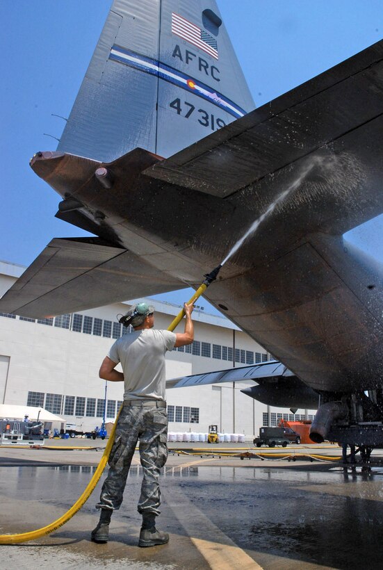 Staff Sgt. Josh Crooks washes down the ramp of a C-130 Hercules prior to a firefighting mission June 29 at McClelland Airfield in Sacramento, Calif. Sergeant Crooks is a reservist with the 302nd Airlift Wing from Peterson Air Force Base, Colo., and assigned to the 302nd Air Expeditionary Group fighting the Corral and Piute wildfires fires near the California capital. (U.S. Air Force photo/Senior Airman Stephen Collier) 