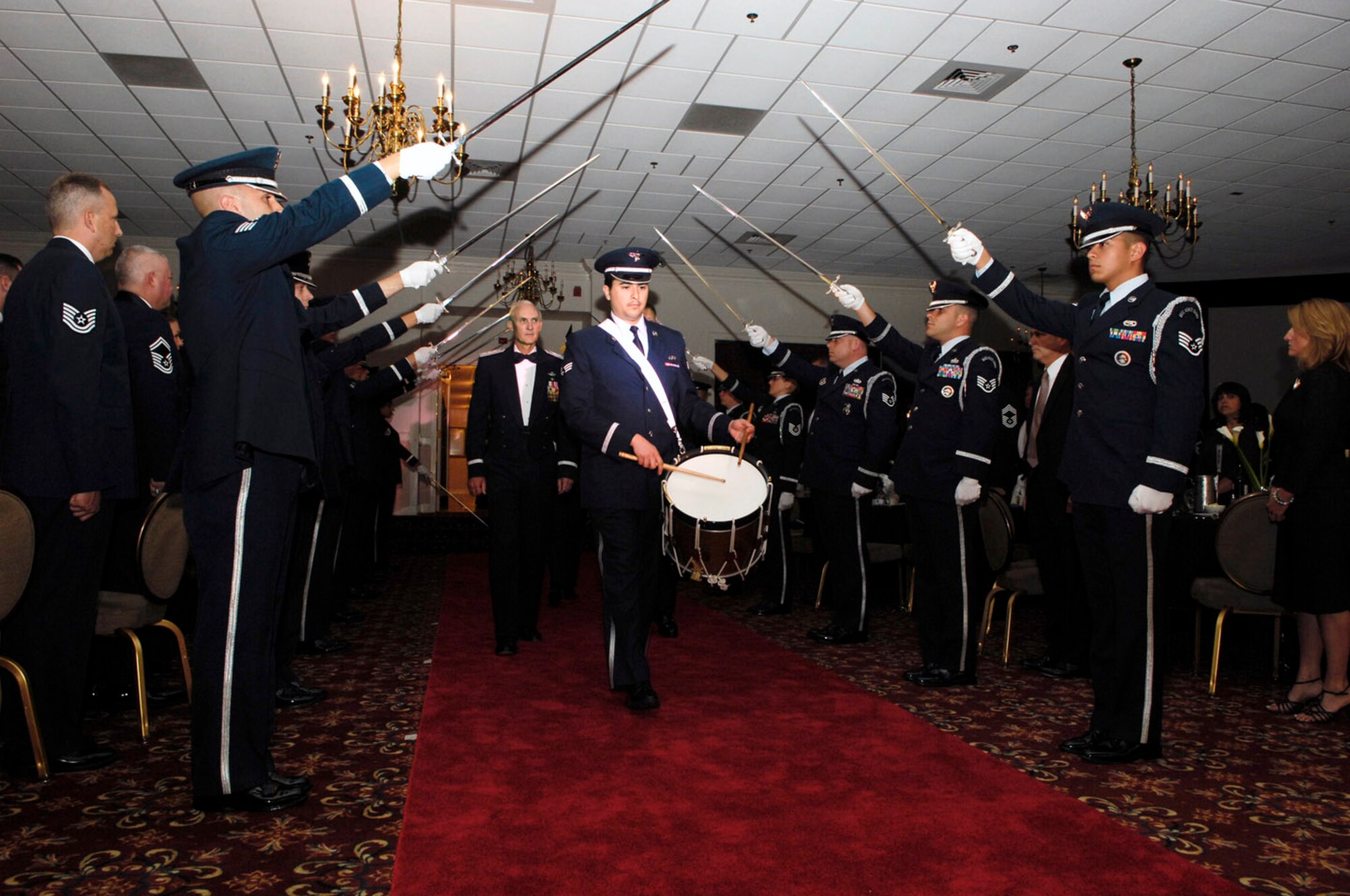 Retired Lt. Gen. Charles L. Johnson II is escorted through an Honor Guard sword cordon during a ceremony June 20 at Hanscom Air Force Base, Mass. General Johnson was inducted into the Air Force Materiel Command Order of the Sword. The Order of the Sword is the highest honor that Air Force NCOs can bestow upon an individual. General Johnson is the former Electronic Systems Center commander. (U.S. Air Force photo/Mark Wyatt.) 