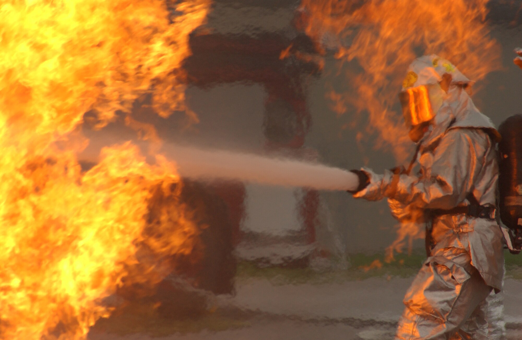 Firefighters from the 115th Fighter Wing, Madison, Wisconsin, practice fire suppression techniques during a simulated aircraft mishap at Volk Field CRTC, Wisconsin on 6 May, 2007. Volk Field is one of a handful of Combat Readiness Training Centers that  hosts unit level military training exercises to prepare them for world wide deployments.  (U.S Air Force  Photo by SSgt Katherine Kane) (RELEASED)