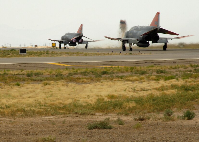 Two unmanned QF-4 drones prepare for take off at Holloman Air Force Base, N.M., June 25. A film crew came to Holloman to film documentary segments about the F-22A Raptor and the QF-4 drone for Discovery Channel Canada's "Daily Planet" show. (U.S. Air Force photo/Airman 1st Class Michael Means)