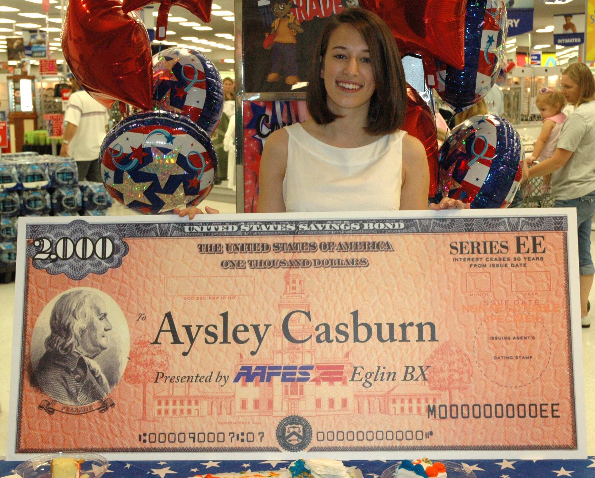 EGLIN AIR FORCE BASE, Fla. -- You Made the Grade winner Aysley Casburn was presented a $2000 savings bond at the Army and Air Force Exchange Services here June 30 in recognition for her outstanding academic achievments. AAFES and vendor partners award bonds for $5,000, $3,000, and $2,000 to three students in quarterly drawings. Students eligible to enter must provide a valid military identification card and a report card with an overall B average or better. (U.S. Air Force photo by Airman 1st Class Anthony Jennings)