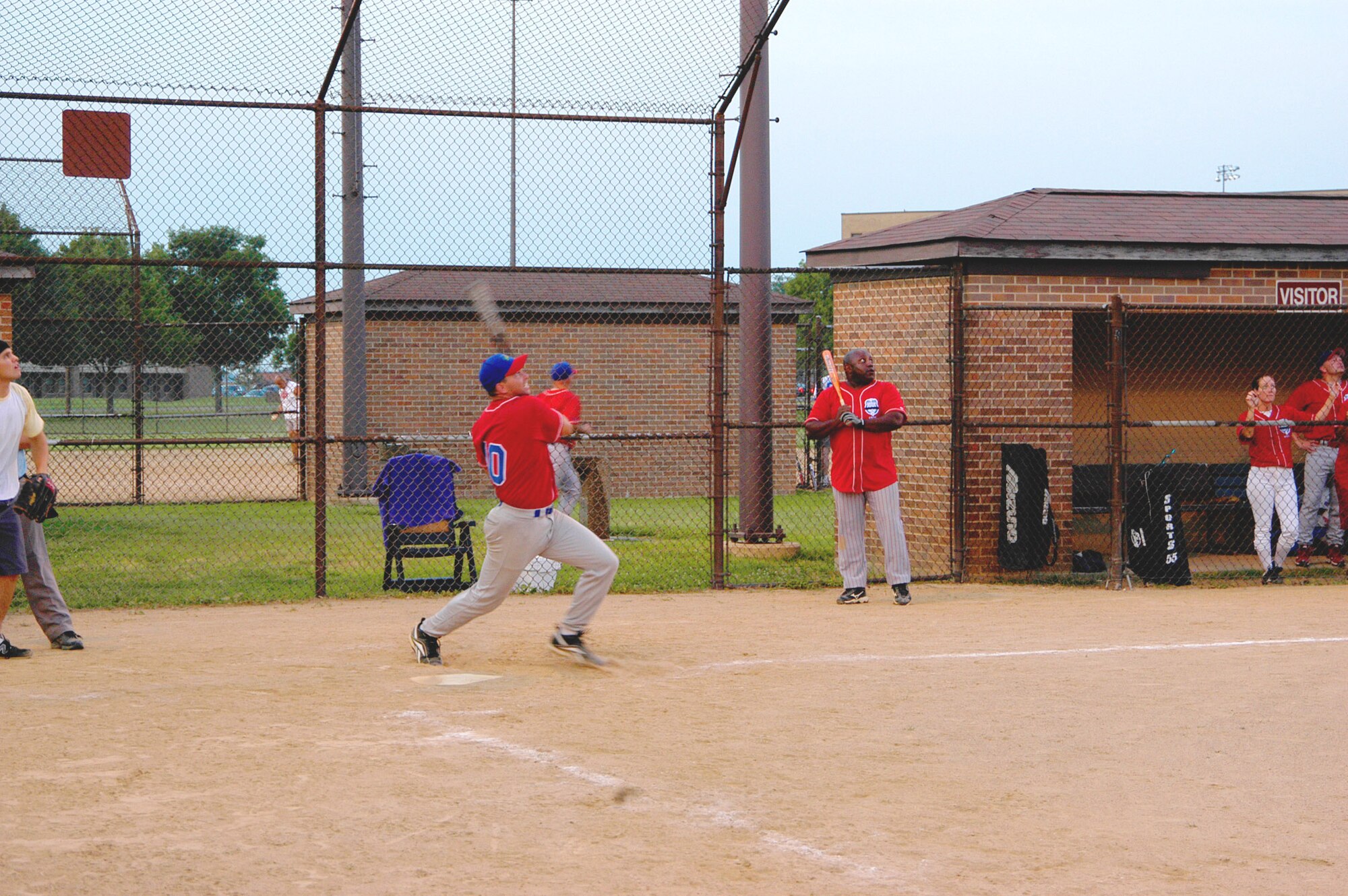 AFOSI Gators' first baseman Jeff Dahlke watches his hit as it heads for and sails over the left field fence for a three-run homer. The Gators bit 744th COMM twice, taking both games of a doubleheader, 10-0 and 13-7 respectively. (U.S. Air Force photo/Tech. Sgt John Jung)                                