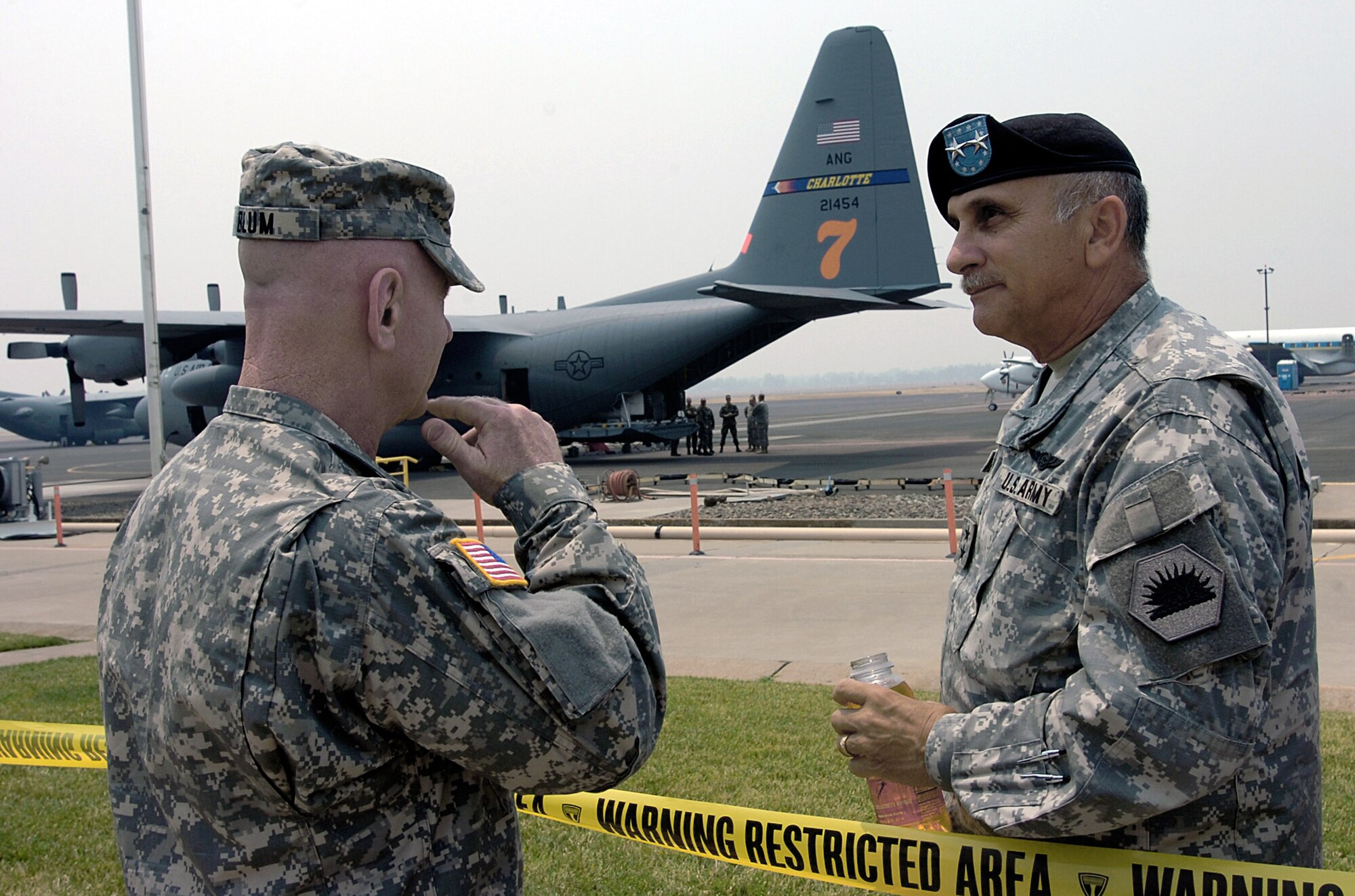 Army Lt. Gen. H. Steven Blum overlooks the wildfire response operations of two North Carolina National Guard C-130 Hercules aircraft from the 145th Airlift Wing with Army Maj. Gen. William Wade June 26 on the airfield at Chico, Calif. General Blum is the chief of the National Guard Bureau, and General Wade is the adjutant general of California. (U.S. Air Force photo/Master Sgt. Mike R. Smith)
