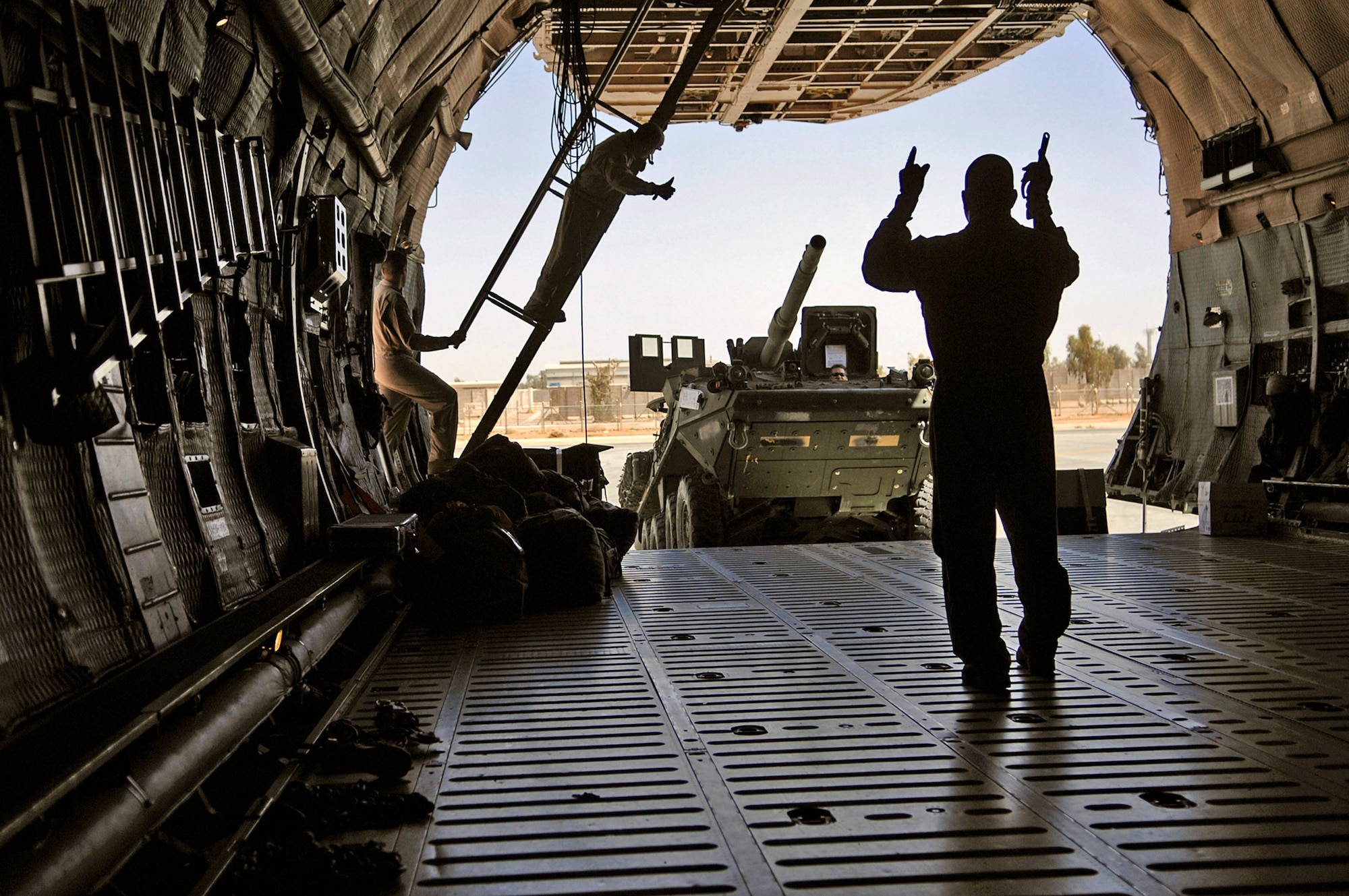 C-5 Galaxy crewmembers along with aerial port Airmen assigned to the 332nd Expeditionary Logistics Readiness Squadron load an Army Stryker Infantry Carrier Vehicle onto a C-5 Galaxy June 25 at Joint Base Balad, Iraq. With a maximum cargo weight of 270,000 pounds the C-5 can carry more than any other Air Force airlifter. The C-5 is from Dover Air Force Base, Del. (U.S. Air Force photo/Senior Airman Julianne Showalter) 
