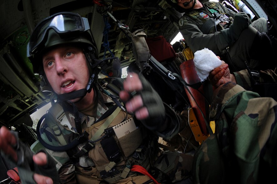 MOODY AIR FORCE, Ga. -- Senior Airman Anthony Deroest, 38th Rescue Squadron pararescueman, gives instructions to mock patients before off-loading an HH-60G Pave Hawk during a mass casualty exercise here June 27. The patient's injuries varied from sprained ankles and fractures to an abdominal evisceration. (U.S. Air Force photo by Senior Airman Gina Chiaverotti)