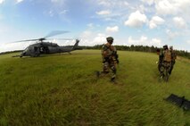 MOODY AIR FORCE BASE, Ga. -- 38th Rescue Squadron pararescuemen take a mock patient to a waiting HH-60G Pave Hawk during a mass casualty exercise here June 27. The patients were being transported to an HC-130P King for medical evacuation after a staged helicopter crash. (U.S. Air Force photo by Senior Airman Gina Chiaverotti)
