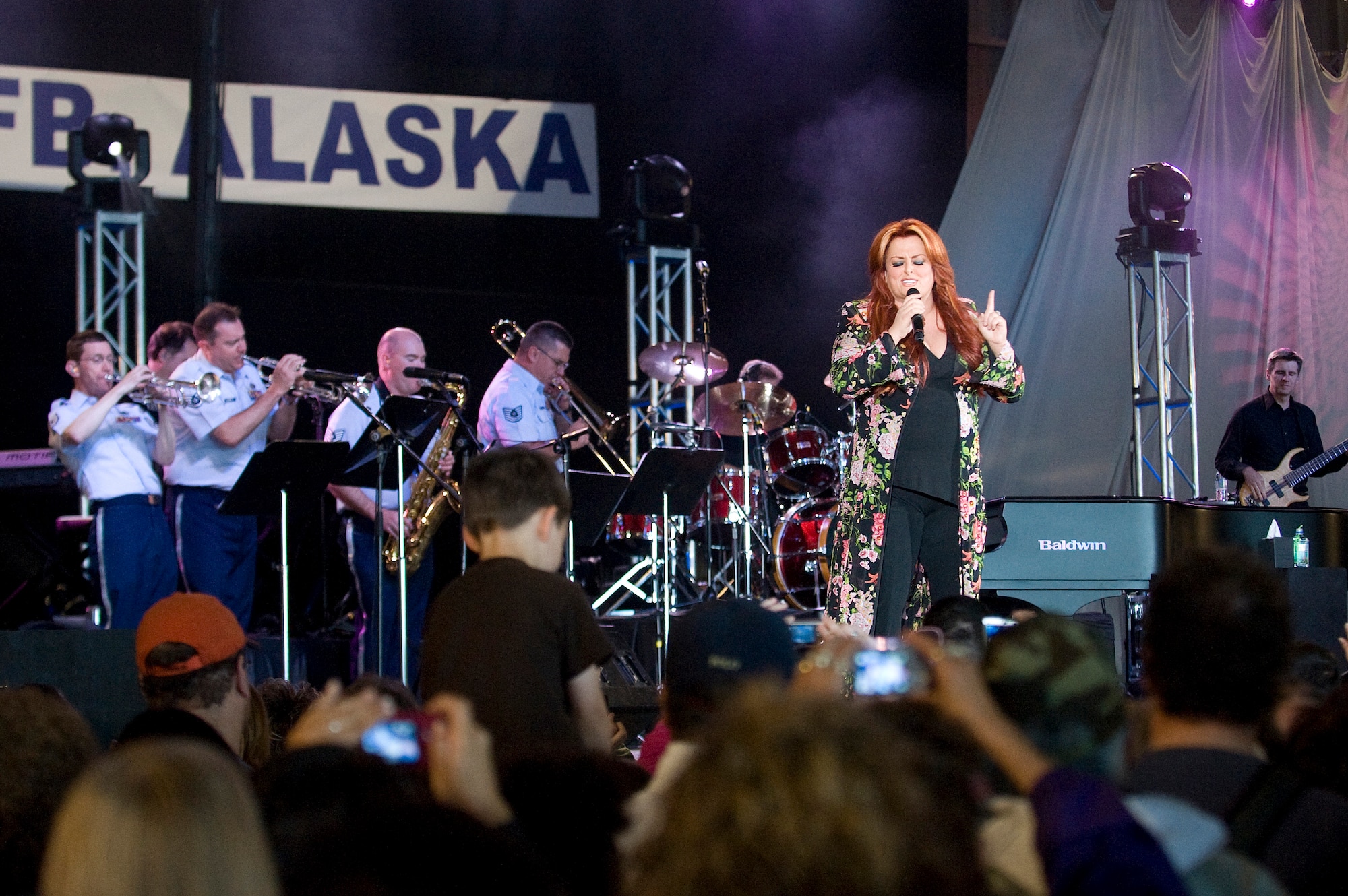 ELMENDORF AIR FORCE BASE, Alaska -- Wynonna Judd performs with the U.S. Air Force Band of the Pacific to the military and Alaska crowd at the "Alaska's Concert for the Military" June 27 at Hangar 2. The concert was a part of Alaska's 50 years statehood celebration. (U.S. Air Force photo by Senior Airman Jonathan Steffen)