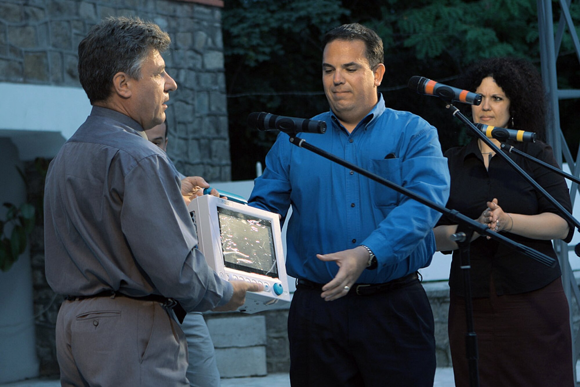 Chaplain (Maj.) Vincent Cummings presents a new pulse oximeter to Dr. Stefan Lazarov from the Medical University June 23 in Plovdiv, Bulgaria. Approximately 200 Airmen Homestead Air Reserve Base, Fla., deployed to train with the Bulgarian air force. The Airmen raised $2,800 to purchase a medical device for the children's ward that is useful for patients with respiratory or cardiac problems. Chaplain Cummings is a 482nd Fighter Wing chaplain. (U.S. Air Force photo/Tech. Sgt. Bucky Parrish) 
