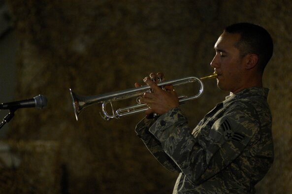 BAGRAM AIR FIELD, Afghanistan--Senior Airman Patrick Brush, U.S. Air Forces Band ‘Falcon’ trumpet player, captivates an audience with the smooth sounds of his trumpet during a show here June 22.  Airman Brush is deployed from the  USAF Heartland of America Band, Offutt AFB, Neb.   ‘Falcon’ travels throughout the area of responsibility positively promoting troop morale, diplomacy and reach out to host nation communities.  (U.S. Air Force Photo By/Master Sgt. Demetrius Lester)