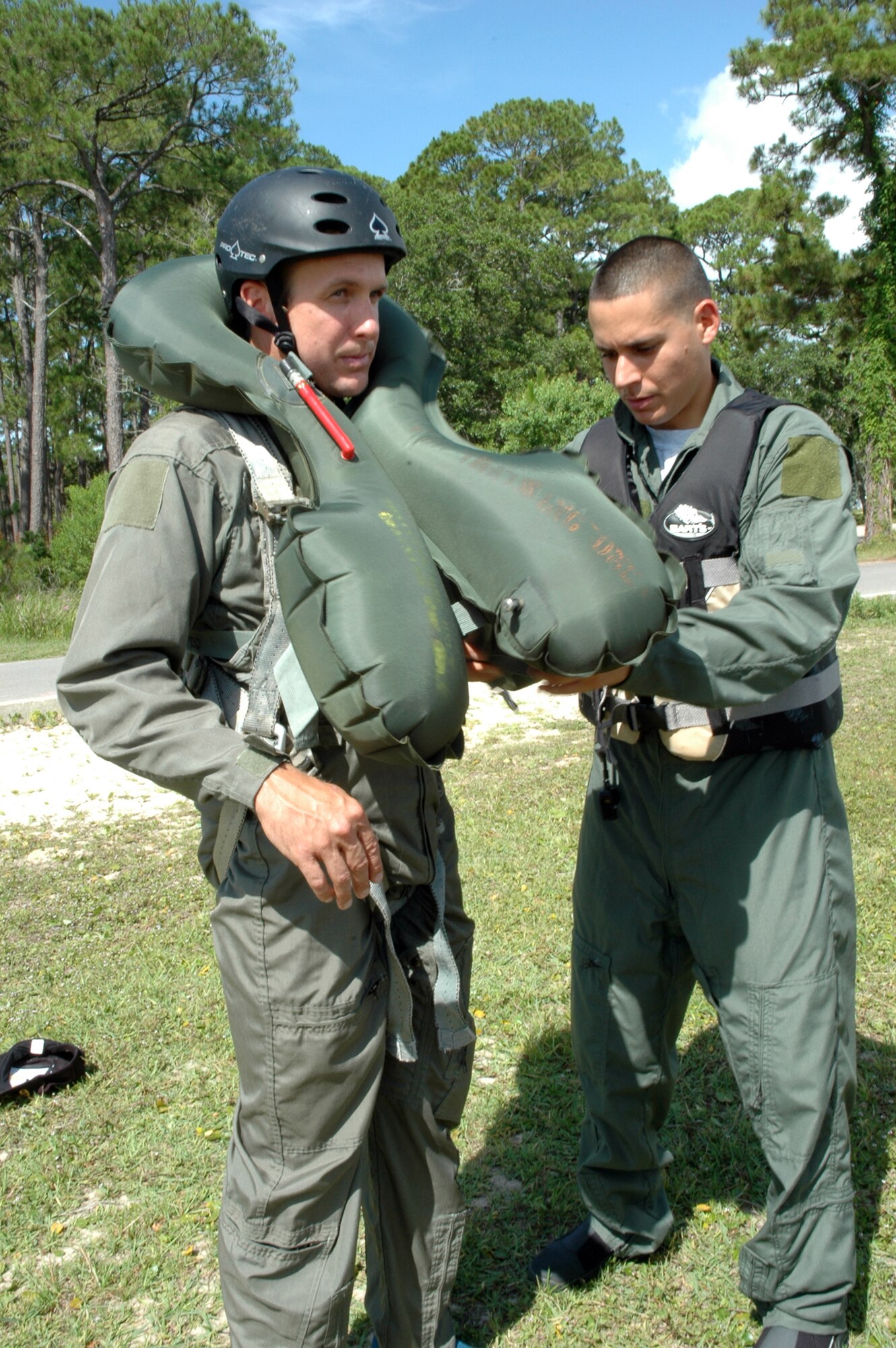 EGLIN AIR FORCE BASE, Fla. -- Staff Sgt. Maikel Figueroa, 46th Operations Support Squadron life support aircrew training NCOIC, adjusts a survival harness for Paul Palmer, 96th Air Base Wing honorary commander, during water survival training June 26 at Post'l Point. Five honorary commanders participated in the training, which refreshes pilots on the use of water survival equipment in case of an emergency landing or ejection over the ocean. (U.S. Air Force photo by Staff Sgt. LuCelia Ball) 