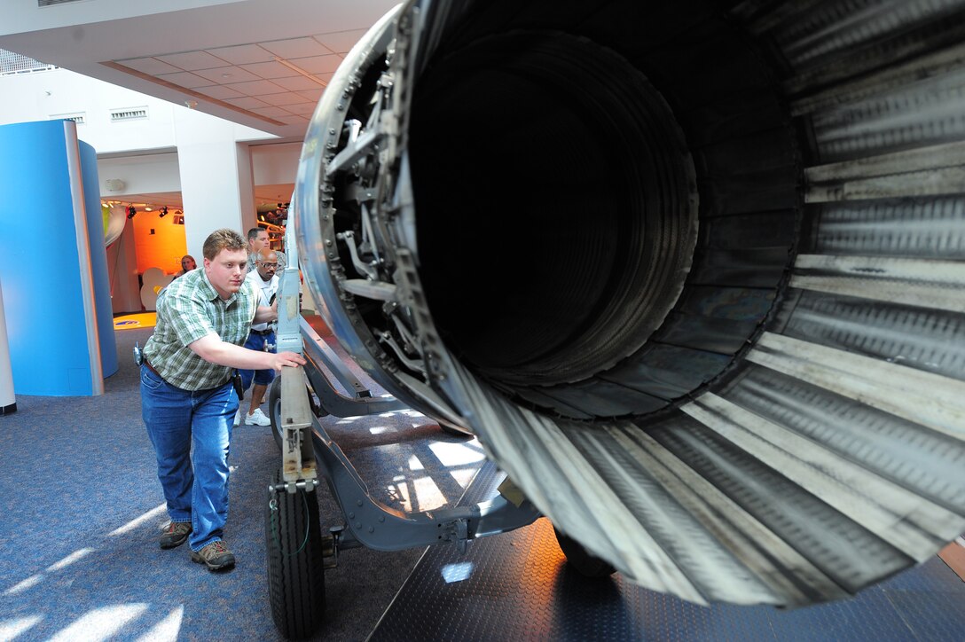 LANGLEY AIR FORCE BASE, Va. -- Mr. Kurt Klein, exhibit technician, puts an F100-100 jet engine on exhibit at the Virginia Air and Space Center June 27. The engine was loaned by the National Museum of the U.S. Air Force via Langley Air Force Base. (U.S. Air Force photo/Staff Sgt. Barry Loo)