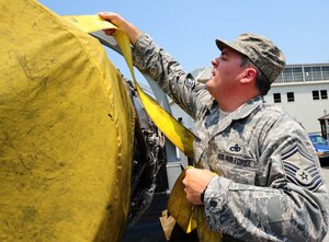 LANGLEY AIR FORCE BASE, Va. -- Senior Master Sgt. Scott Cloutier, 1st Component Maintenance Squadron propulsion flight chief, secures an F100-100 jet engine onto a truck destined for the Virginia Air and Space Center June 27.  The engine was loaned by the National Museum of the U.S. Air Force via Langley Air Force Base.  "It's a beautifully polished and clean engine," Sergeant Cloutier said. "I'd hate to see it go to the scrap yard." (U.S. Air Force photo/Staff Sgt. Barry Loo)
