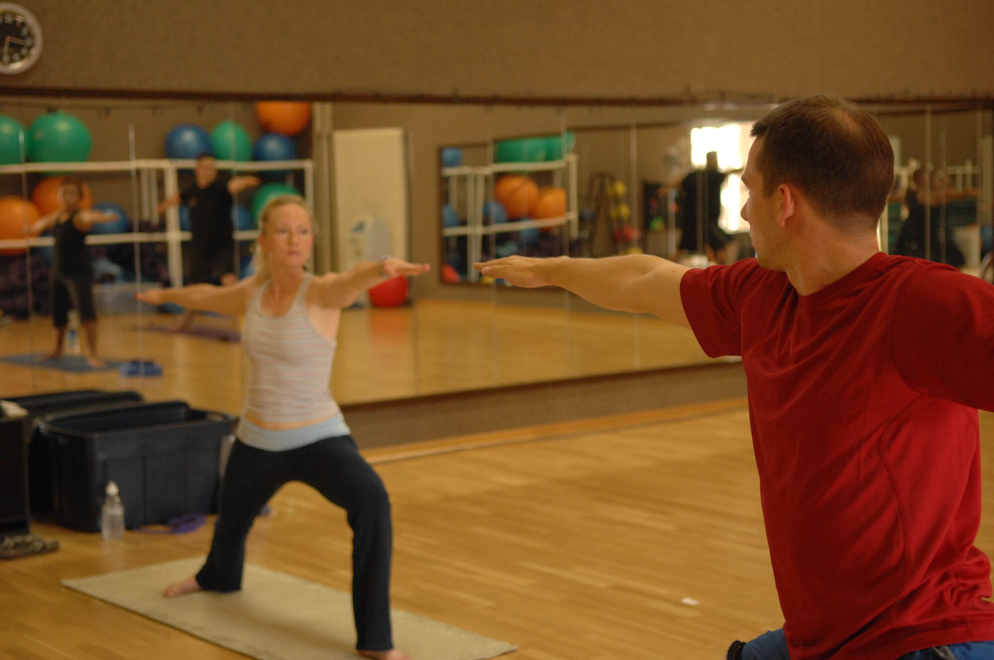 SPANGDAHLEM AIR BASE, Germany – Capt. James Gingras, 52nd Civil Engineer Squadron, participates in a yoga class led by his wife, Anna Gingras, June 26, 2008. These $5 yoga classes are offered at the Skelton Memorial Fitness Center. U.S. Air Force photo by Airman Staci Miller