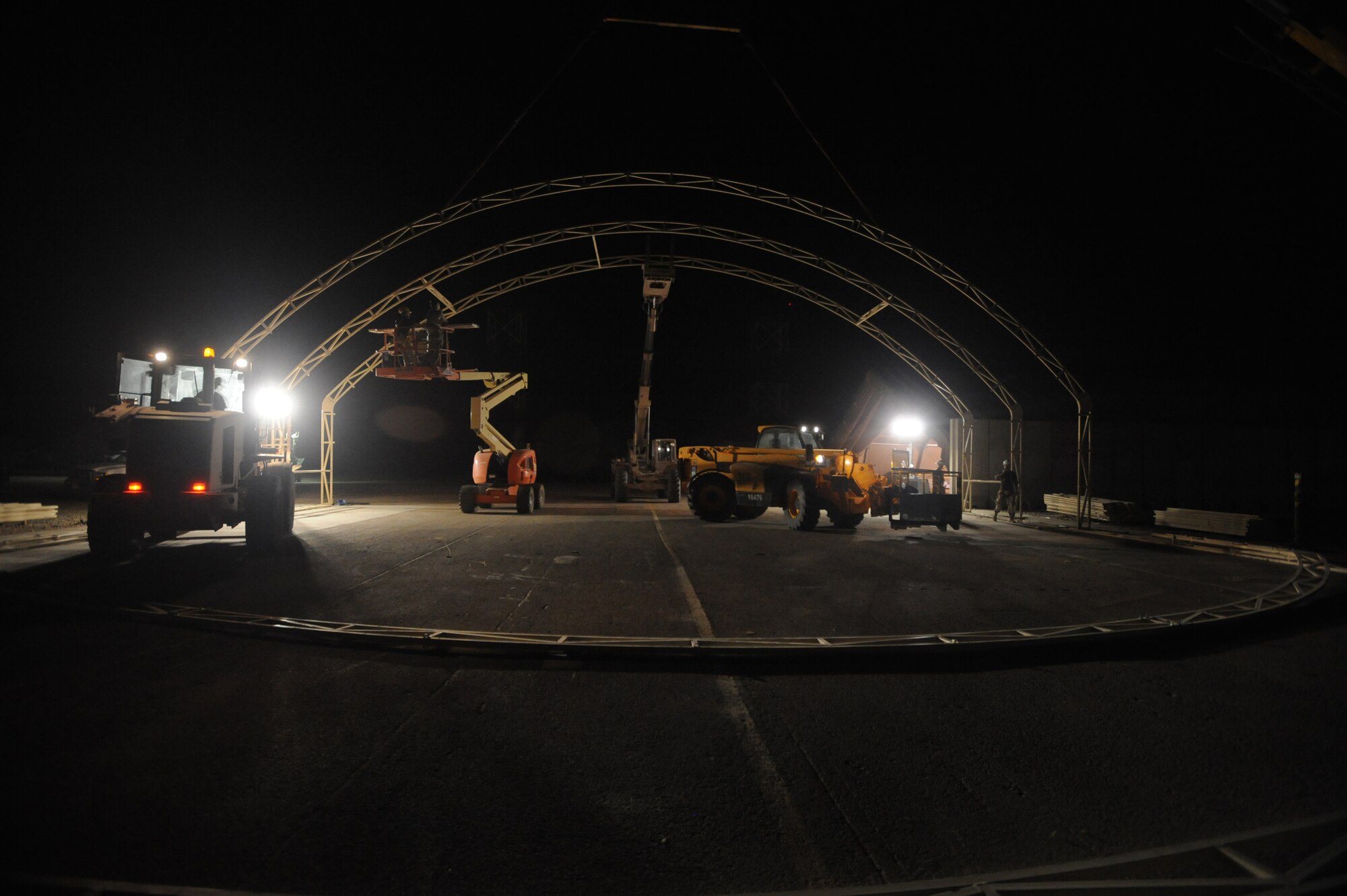 ALI BASE, Iraq -- Airmen of the 407th Expeditionary Civil Engineer structures team, construct a 22X22 meter sun shade at the Alpha site during the evening hours to beat the 116 degree temperatures during the day. The shelter will be used to house the Predator MQ-1B Unmanned Aerial Vehicle that provides intelligence, surveillance and reconnaissance to coalition forces throughout Iraq. (U.S. Air Force photo/Tech. Sgt. Sabrina Johnson) 