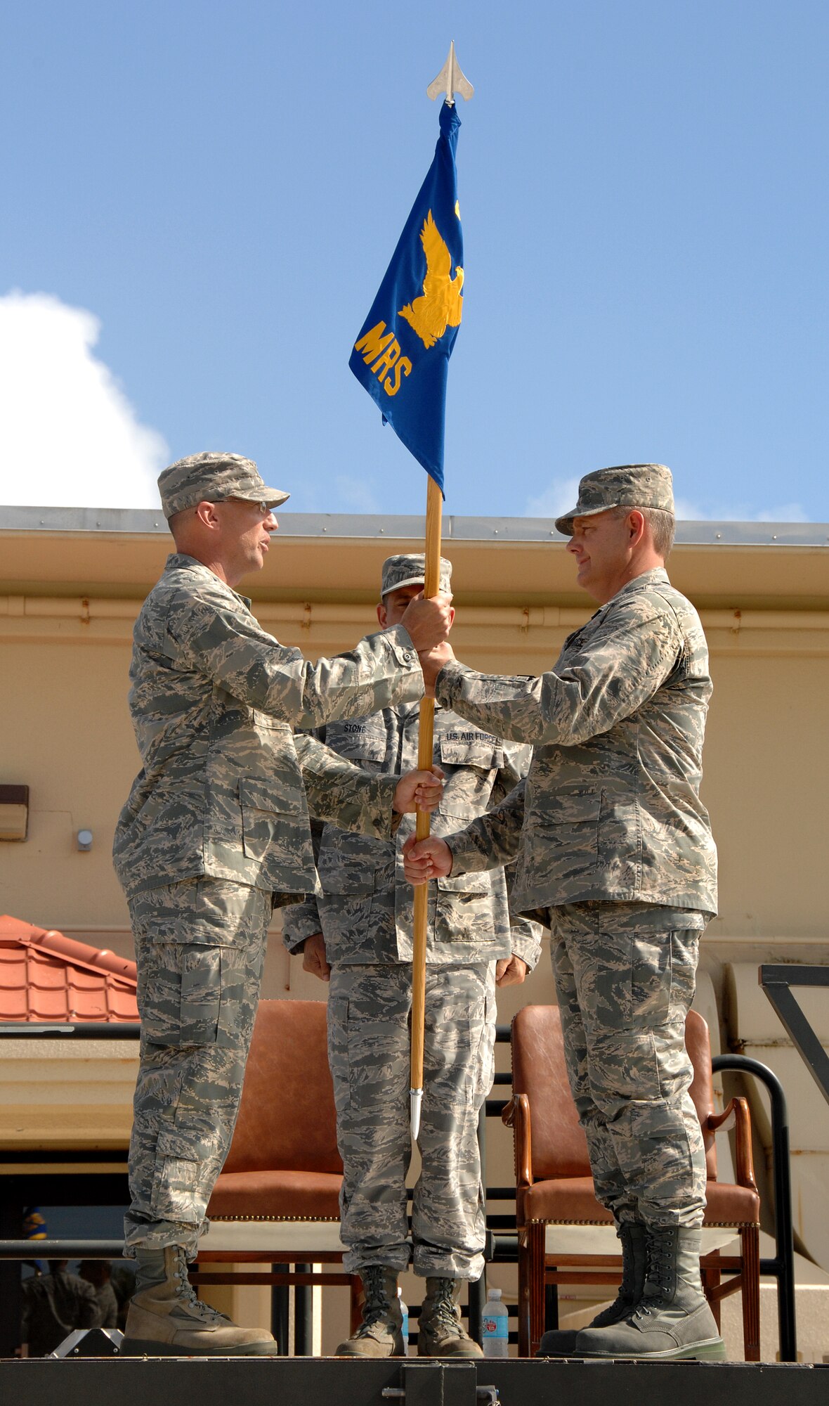 Presiding Officer Col. Kevin Kersh presents the 36th Mobility Response Squadron flag to Lt. Col. Joe Hayslett, giving him command of the 36th MRS during the change of command ceremony here June 27. (U.S. Air Force photo by Airman 1st Class Courtney Witt)