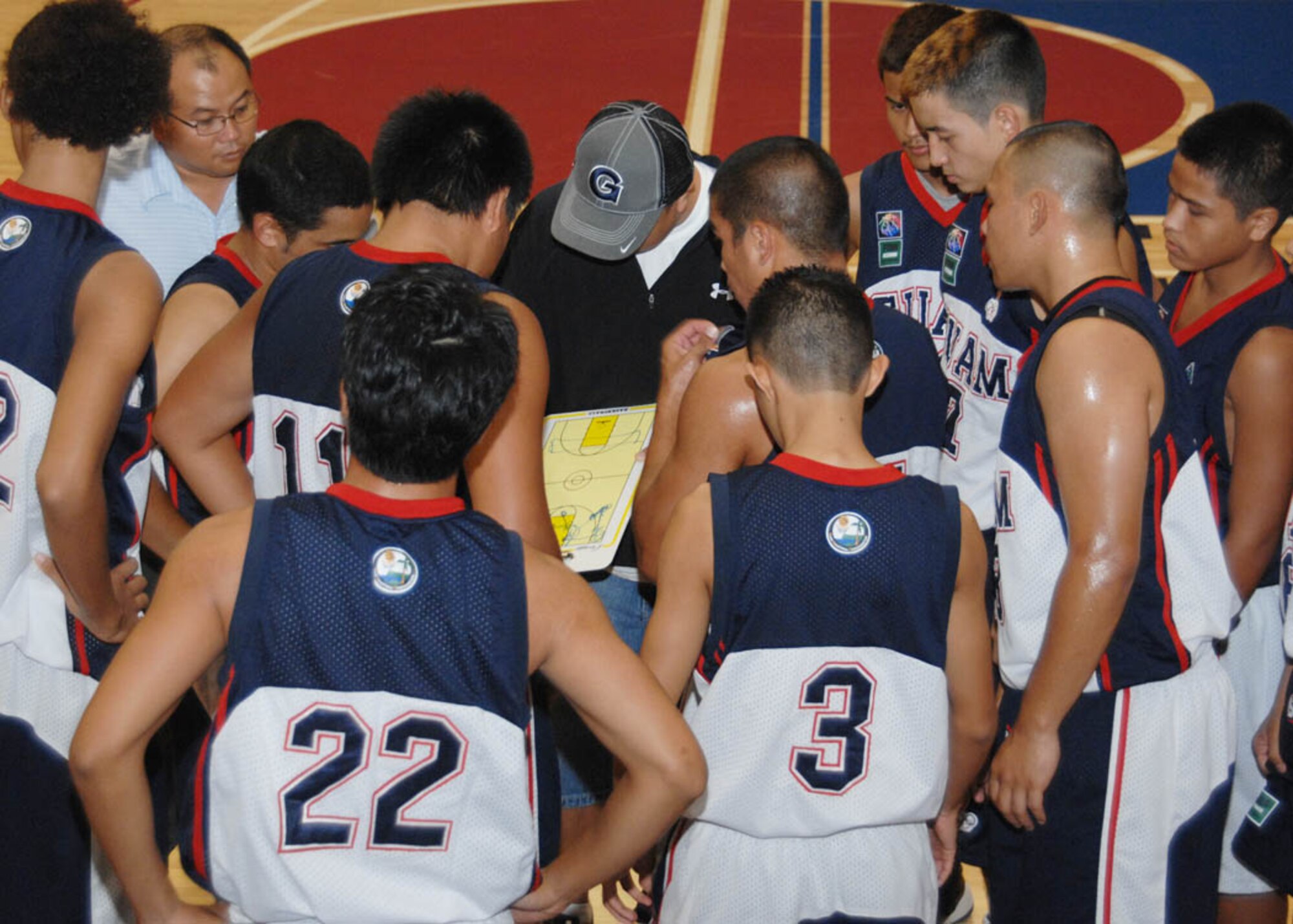 The Guam Junior National Basketball Team huddles up while the coach reviews plays during a time out in the first game of the Andersen Summer Slam against the Ace hardware Aces here June 27. The Guam Junior Basketball Team beat the Aces 74 to 73 in a double overtime fight to the finish. (U.S. Air Force photo by Airman 1st Class Nichelle Griffiths)
