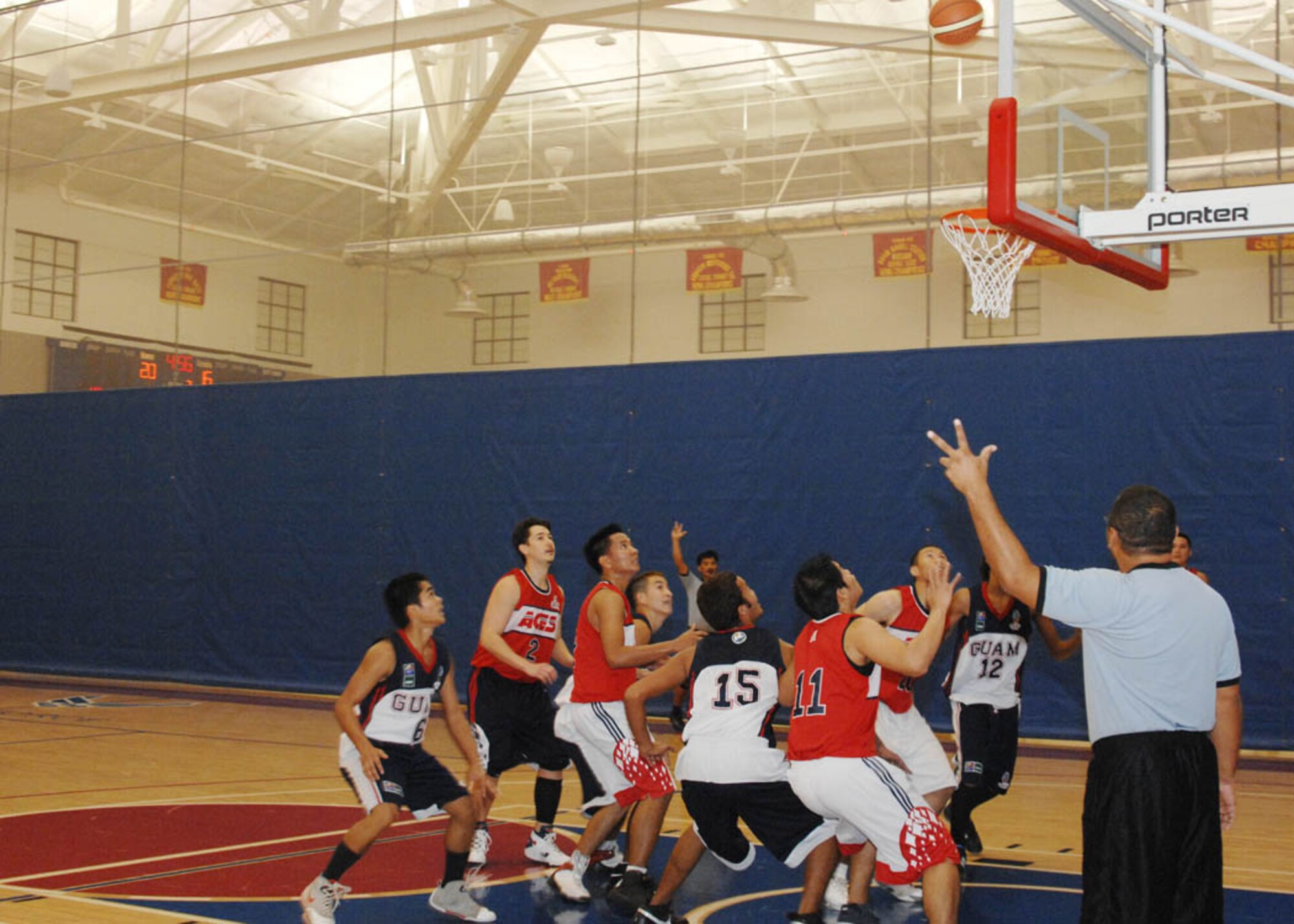 The Guam Junior Basketball Team and the Ace Hardware Aces anxiously wait under the hoop for a possible rebound during the first game in the Andersen Summer Slam tournament at the Coral Reef Fitness Center June 27. The Andersen Summer Slam is held annually at Andersen AFB with various teams  around the island and the Pacific Air Forces. (U.S. Air Force photo by Airman 1st Class Nichelle Griffiths)