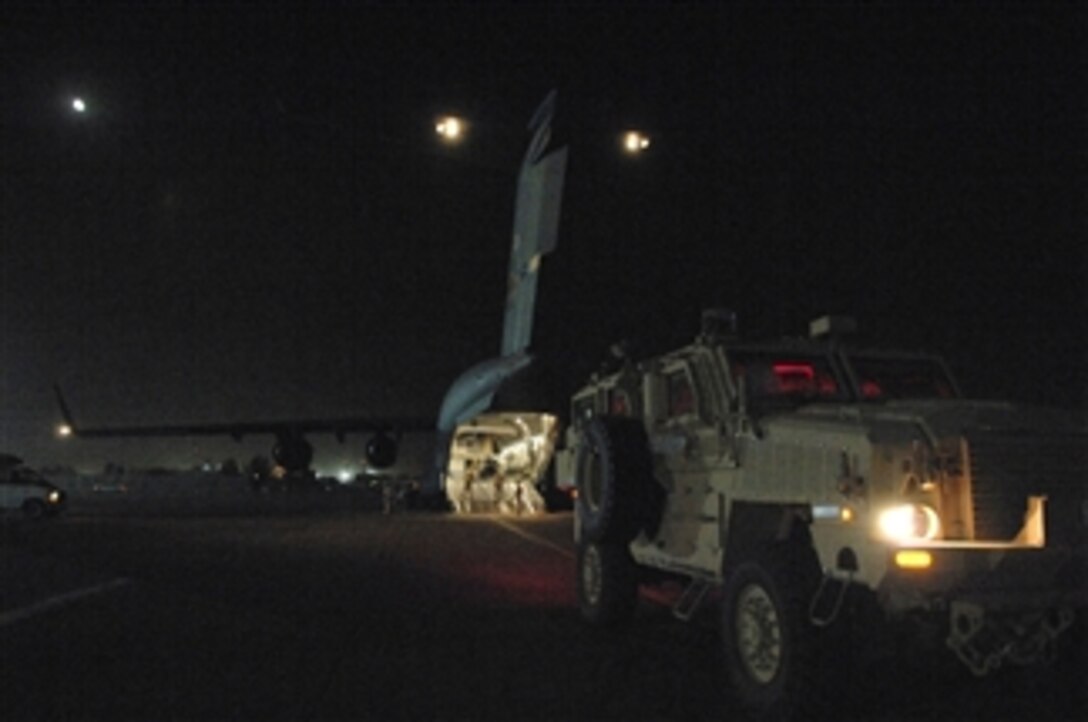 A mine-resistant, ambush-protected armored vehicle waits for loading onto a C-17 Globemaster III aircraft at Joint Base Balad, Iraq, on June 24, 2008.  The distribution of these vehicles is critical to the survival of service members operating in a combat environment where they may face improvised explosive device attacks.  