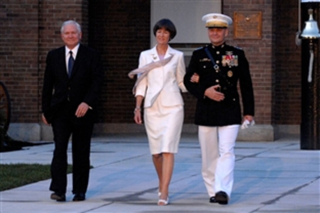 Defense Secretary Robert M. Gates, left, Sandee Cartwright and her husband Marine Gen. James E. Cartwright, vice chairman of the Joint Chiefs of Staff, walk out before an evening parade at Marine Barracks Washington, D.C., June 27, 2008. Cartwright was the host for the event.