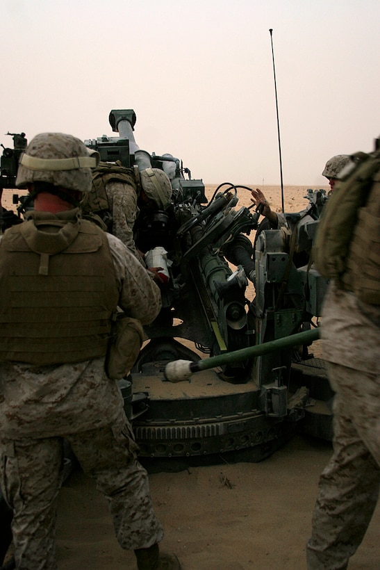 CAMP BUEHRING, Kuwait (July 3, 2008)--Lance Cpl. David R. Wyble, a 25 year-old native of Tulsa, Okla., and an ammunition team chief with India Battery, Battalion Landing Team 2/5, 15th Marine Expeditionary Unit, carries 155mm artillery round to his M777 Howitzer.::r::::n::Wyble, along with the rest of India Btry were conducting sustainment training on one of the many training ranges here.::r::::n::The Camp Pendleton, Calif., based 15th MEU is currently in Kuwait conducting sustainment training. (Official USMC photo by Staff Sgt. TG Kessler)(Released)