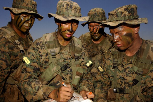Pfc. Kevin J. Chan, Platoon 2110, Company E, with pen, takes a moment to ensure that he and his team have a consensus on their plan to locate the ammunition cans during the Land Navigation Course. Company E recruits went through the exercise at Edson Range, Camp Pendleton Calif., July 1 during their Field Week training.