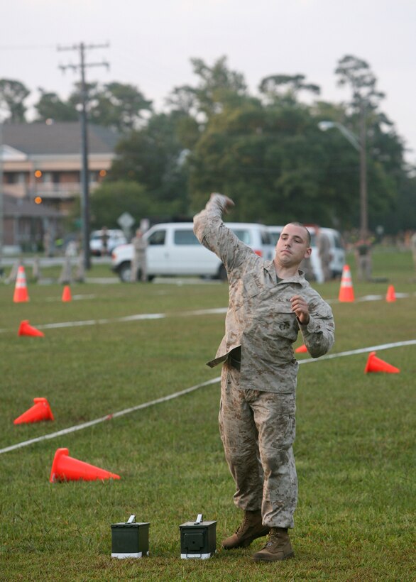 Cpl. Ryan Webster, a motor transport mechanic with the 22nd Marine Expeditionary Unit Command Element, hurls a dummy grenade while training for the new Combat Fitness Test aboard Camp Lejeune, N.C., June 30, 2008. Marines will be required to complete the CFT in conjunction with the semi-annual Physical Fitness Test beginning July 1, 2008. The Marines and sailors of the 22nd MEU are currently training in preparation for a deployment next summer. (Official Marine Corps photo by Cpl. Peter R. Miller)
