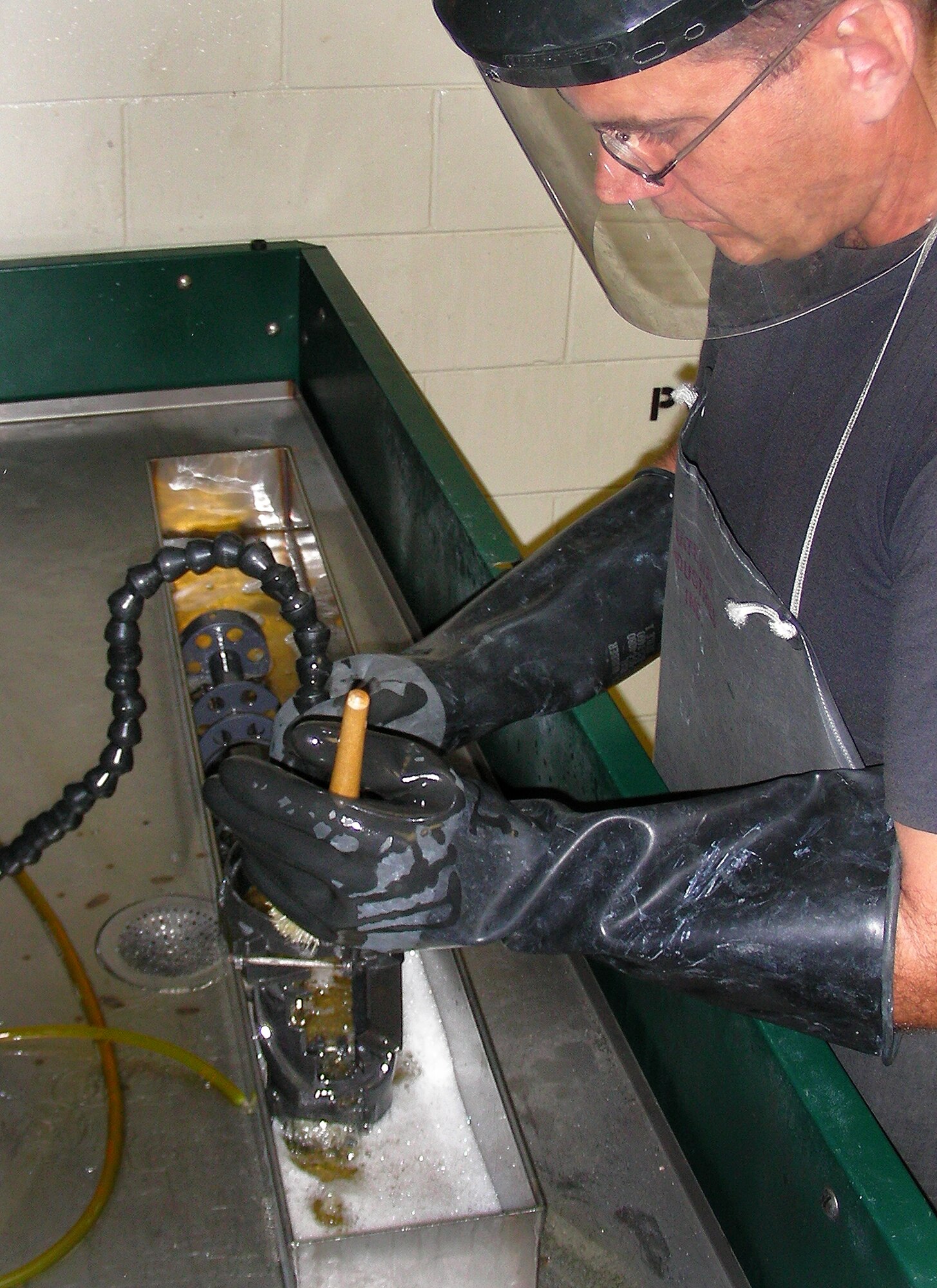 Staff Sgt. Daniel Fried,  an aircraft ordinance mechanic with the 920th maintenance squadron, cleans the GAU-2C machine gun's body in the PCS-25 parts cleaning station. The gun parts are sprayed, scrubbed and bathed in PD-680 solvent. (U.S. Air Force photo/Master Sgt. Raymond F. Padgett)