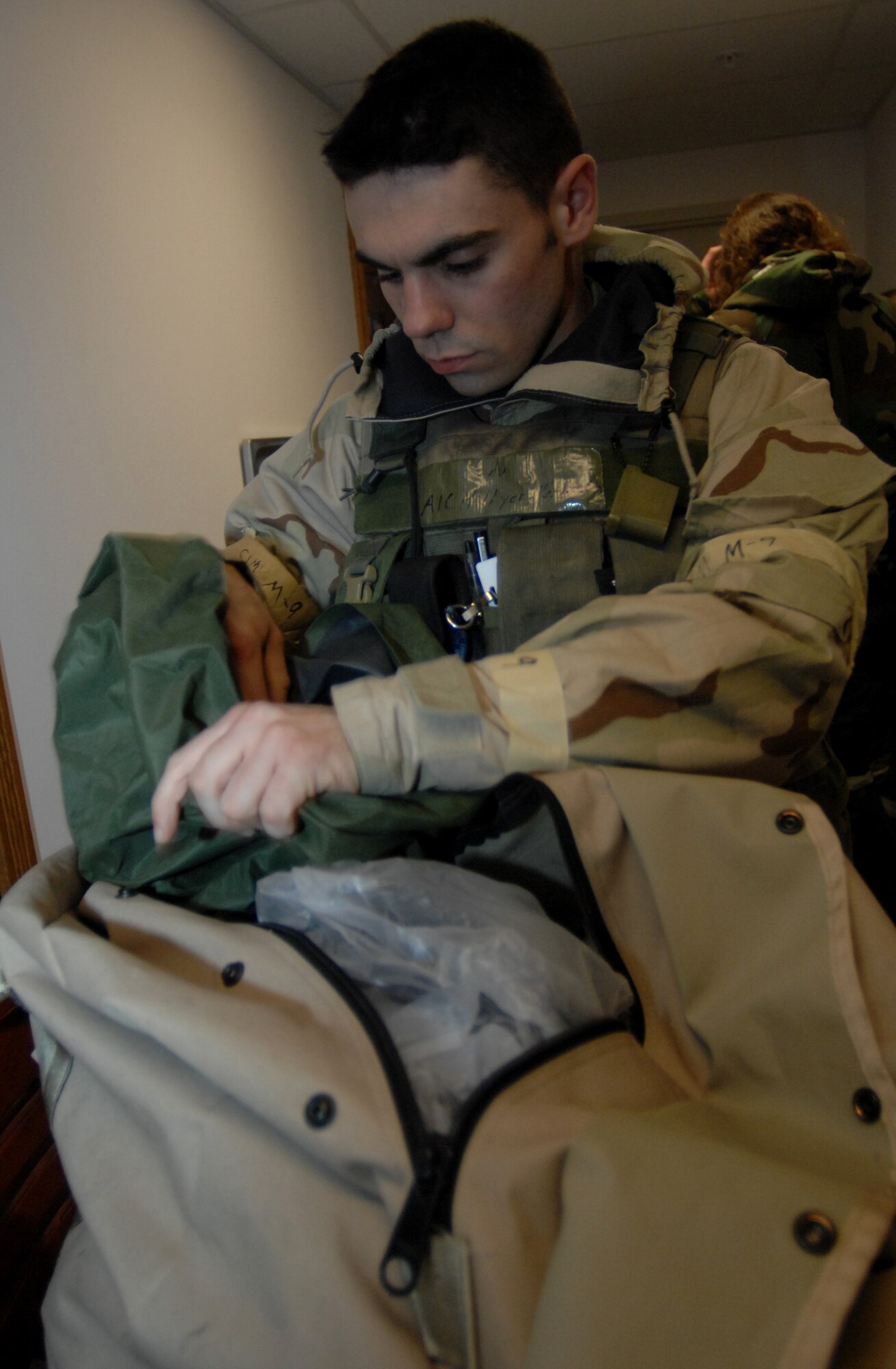 MOUNTAIN HOME AIR FORCE BASE, Idaho-- Airman 1st Class Ken Hillyer, 366th Security Forces Squadron patrolman, searches the bag of Staff Sgt. Brian Stives, 366th Public Affairs chief of internal information, to ensure he is not carrying any prohibited items before entering the command post during Exercise Sharpshooter 08-04.1 March 2. The 366th Fighter Wing conducts exercises to prepare personnel and equipment for the upcoming March 2008 Operational Readiness Inspection. (U.S. Air Force photo/ Airman 1st Class Stephany Miller)
