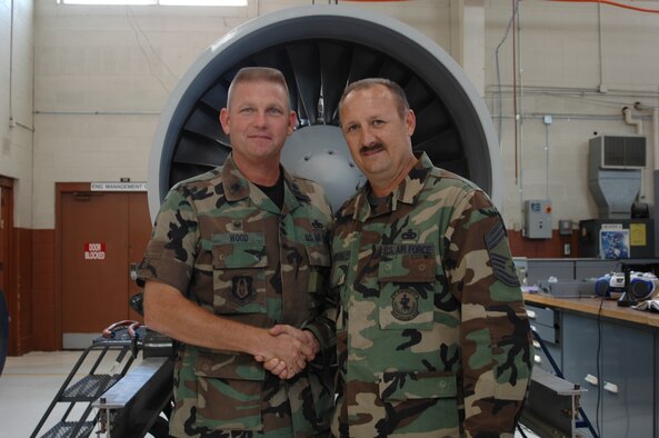 Lt. Col. Michael Wood, outgoing 917th Maintenance Squadron commander, shakes the hand of 917 MXS Superintendent Chief Master Sgt. Tommy Robinson Sept. 20, 2006. (U.S. Air Force photo/Staff Sgt. Ebony Nichols)