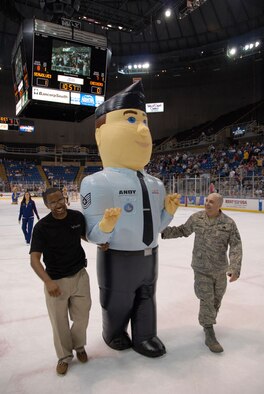 Tech. Sgt. Derrick Cooley on the left and Master Sgt. Neil Sherman escort Airman Andy, the 403rd Wing recruiting mascot, off the ice at the Mississippi Gulf Coast Coliseum. Airman Andy participated in the mascot 'ice hockey' game between periods at the Mississippi Seawolves and Charlotte Checkers hockey game. Andy scored the winning goal and walked away to a standing ovation on Air Force Reserve Appreciation Night. The Seawolves went on to shut-out the Checkers 1-0. (Air Force Photo by Major Chad E. Gibson)