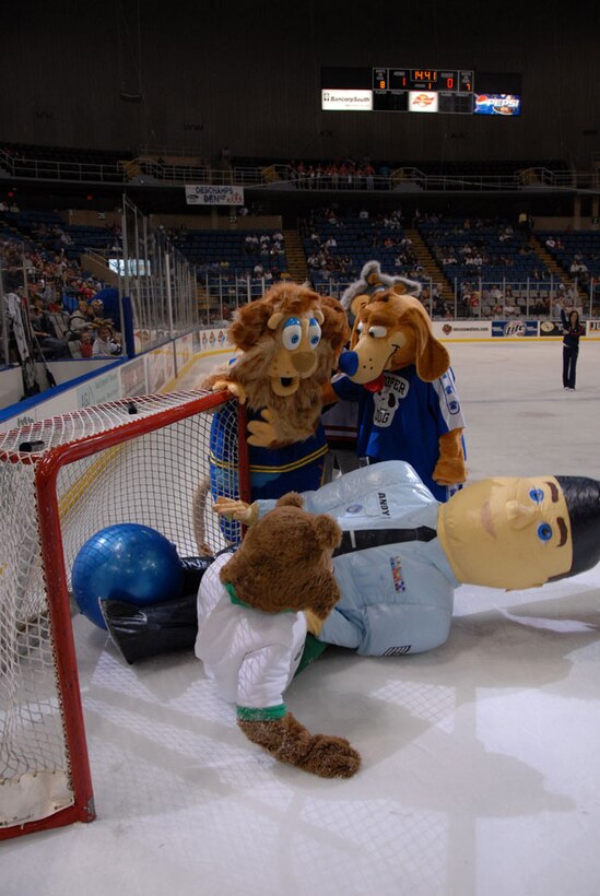 Airman Andy dives in to make the winning goal as area mascots look on during the mascot ice soccer match between periods of the Mississippi Seawolves and Charlotte Checkers hockey game at the Gulf Coast Coliseum. The crowd gave Andy a standing ovation on Air Force Reserve Hockey night on February 29. The Seawolves went on to defeat the Checker 1-0. (Air Force Photo by Major Chad E. Gibson)