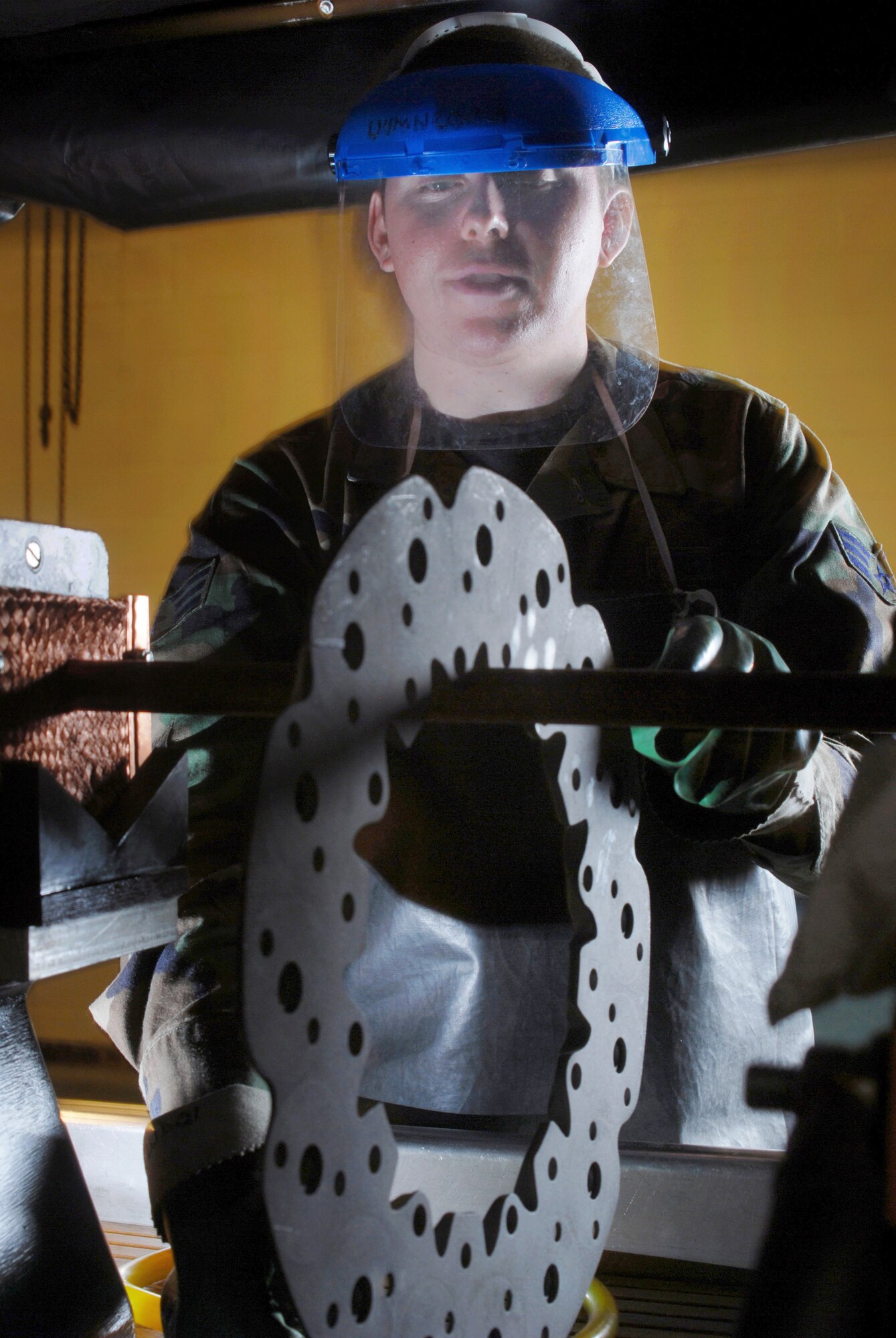 Senior Airman Jason Ray, a non-destructive inspection technician from the 452nd Maintenance Squadron, March Air Reserve Base, Calif., sets up a KC-135 Stratotanker refueling aircraft brake plate for inspection on a magnetic particle machine. He is checking the brake plate for fatigue and cracks. NDI technicians interpret and evaluate indications of test method applied to detect discontinuities and fl aws in aircraft, aerospace ground equipment, component parts, auxiliary equipment and pressurized and fl uid systems. (U.S. Air Force photo by Val Gempis)