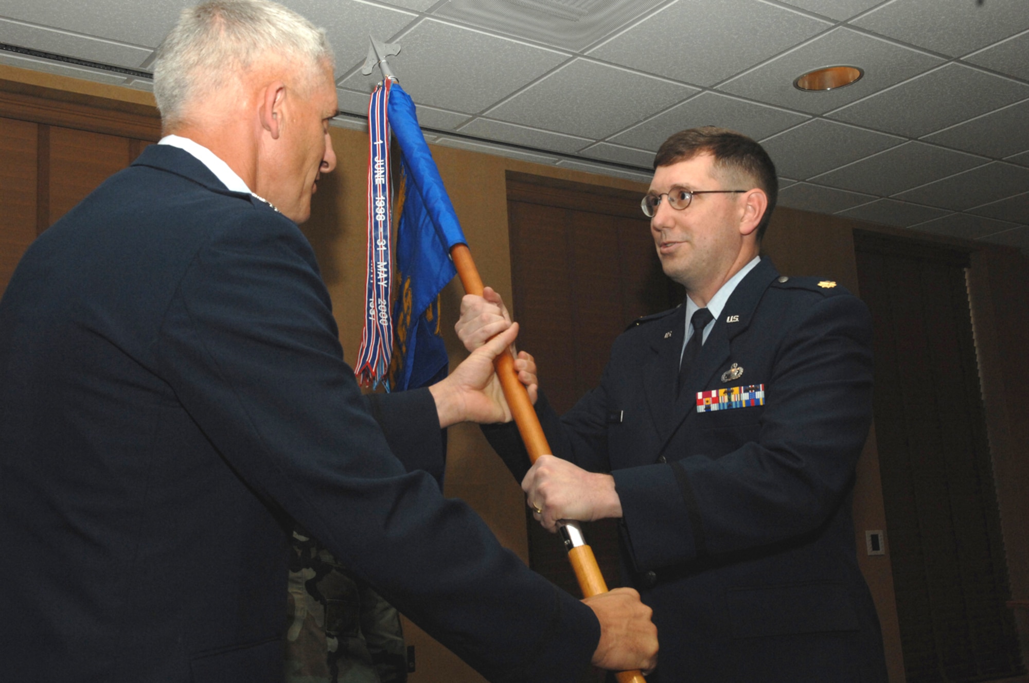 Maj. John F. Landolt, right, assumes command of the 355th Mission Support Squadron as he accepts the squadron flag from the 355th Mission Support Group Commaner Colonel Hal Hoxie Feb. 29. (U.S Air Force photo by Staff Sgt. Lanie McNeal)