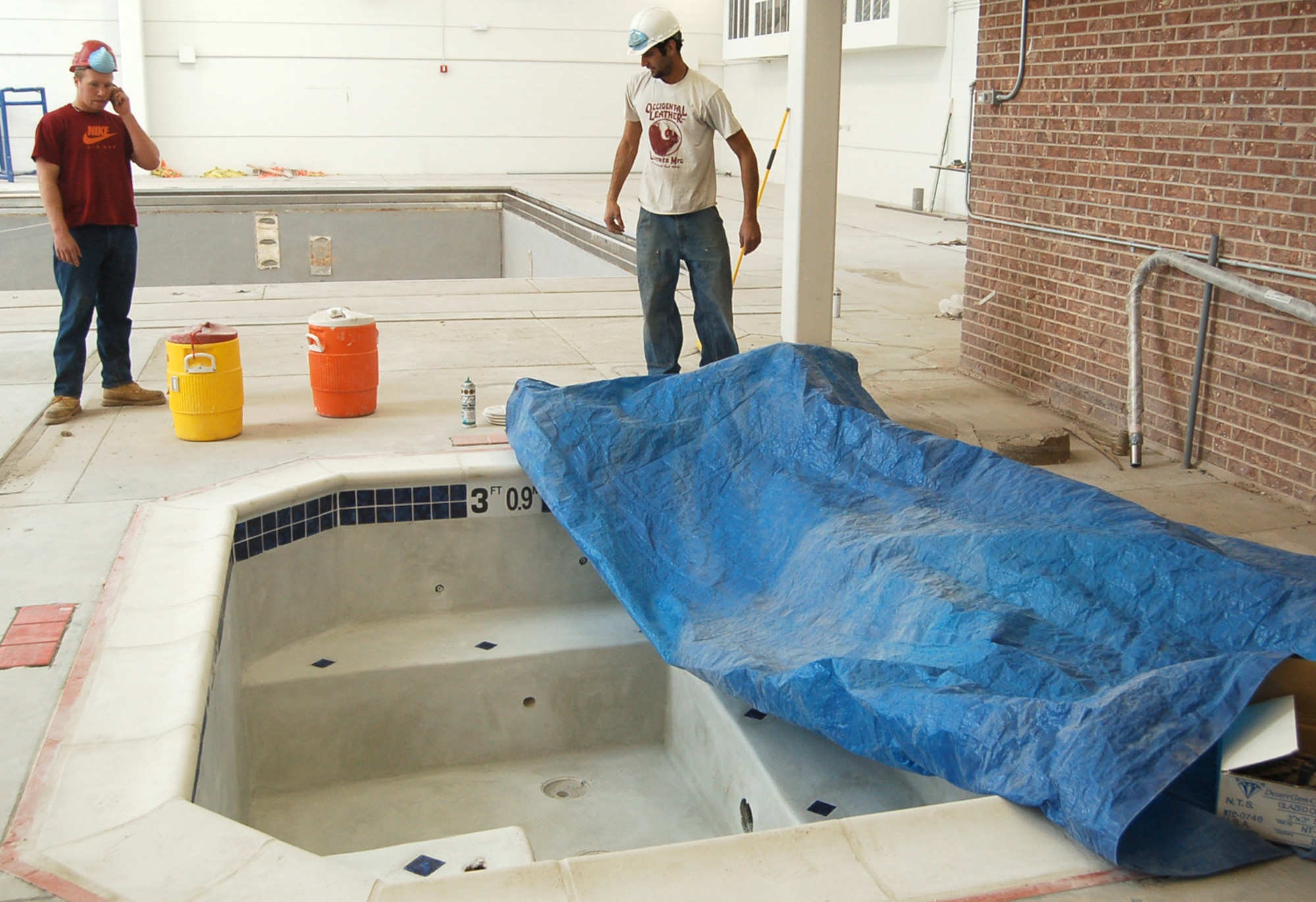 Workers with Innovative Technical Solutions, Inc. show off the new in-ground hot tub at Peterson’s swimming complex. The base pool has undergone extensive upgrades and reopens March 14. (U.S. Air Force photo/Corey Dahl)
