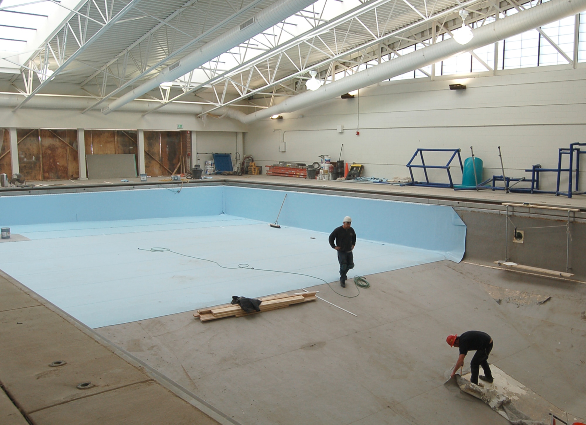 Workers with Innovative Technical Solutions, Inc. tear up the pool’s old liner and replace it with a new one. Peterson’s pool has been closed for renovations since November 2006, but reopens March 14. (U.S. Air Force photo/Corey Dahl)