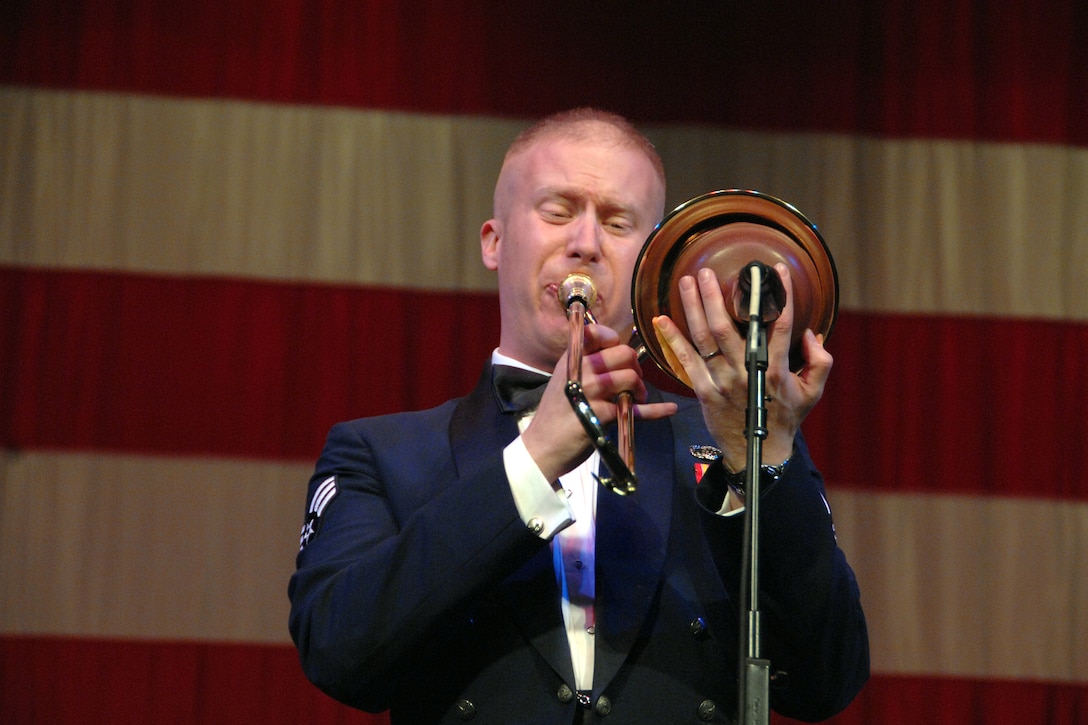 Senior Airman Josh Keen, trombonist with the USAF Heartland of America Band Noteables jazz ensemble, performs on the ever-so-popular plunger mute during an arrangement of "I Love Being Here With You."