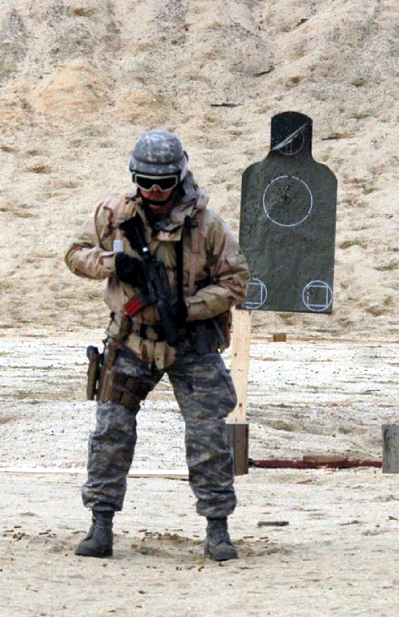 Senior Master Sgt. Brian Gordon waits for his next instructions to shoot during tactical live fire training with an M-4 and M-9 on a range on Fort Dix, N.J., Feb. 27, 2008, as part of training in the Air Advisor Course 08-1.  The course is taught by the U.S. Air Force Expeditionary Center's Expeditionary Operations School and guest instructors preparing Airmen for their roles in training forces in Afghanistan and Iraq.  Sergeant Gordon is from Elmendorf Air Force Base, Alaska.  (U.S. Air Force Photo/Tech. Sgt. Scott T. Sturkol)