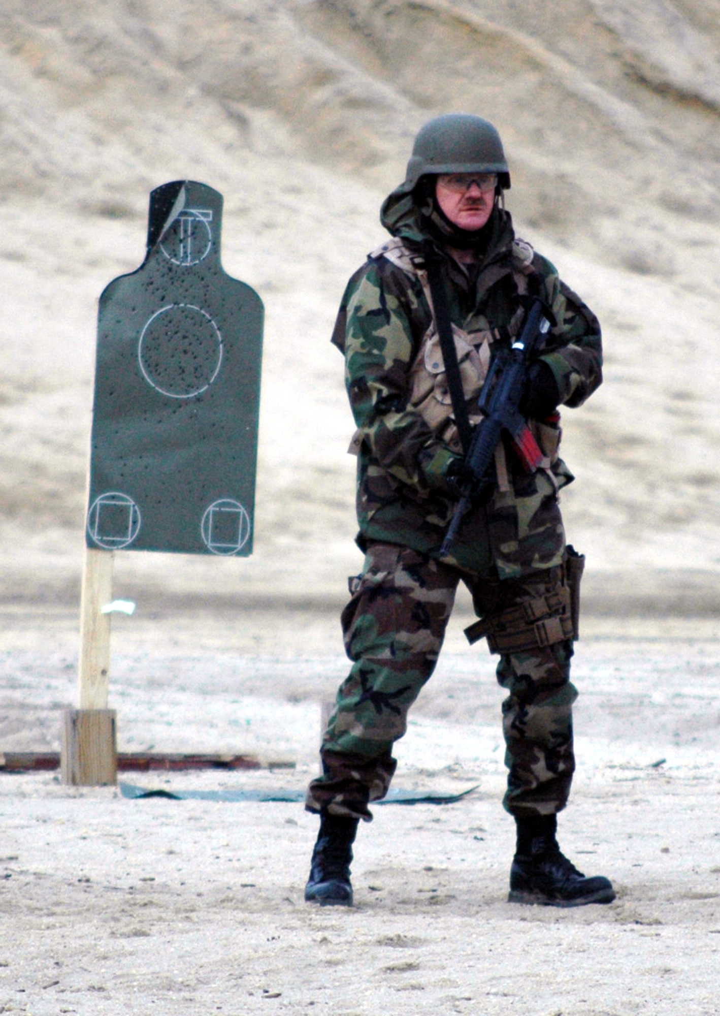 Tech. Sgt. Franklin Cathcart waits for his next instructions to shoot during tactical live fire training with an M-4 and M-9 on a range on Fort Dix, N.J., Feb. 27, 2008, as part of training in the Air Advisor Course 08-1.  The course is taught by the U.S. Air Force Expeditionary Center's Expeditionary Operations School and guest instructors preparing Airmen for their roles in training forces in Afghanistan and Iraq.  Sergeant Cathcart is from Eglin Air Force Base, Fla.  (U.S. Air Force Photo/Tech. Sgt. Scott T. Sturkol)