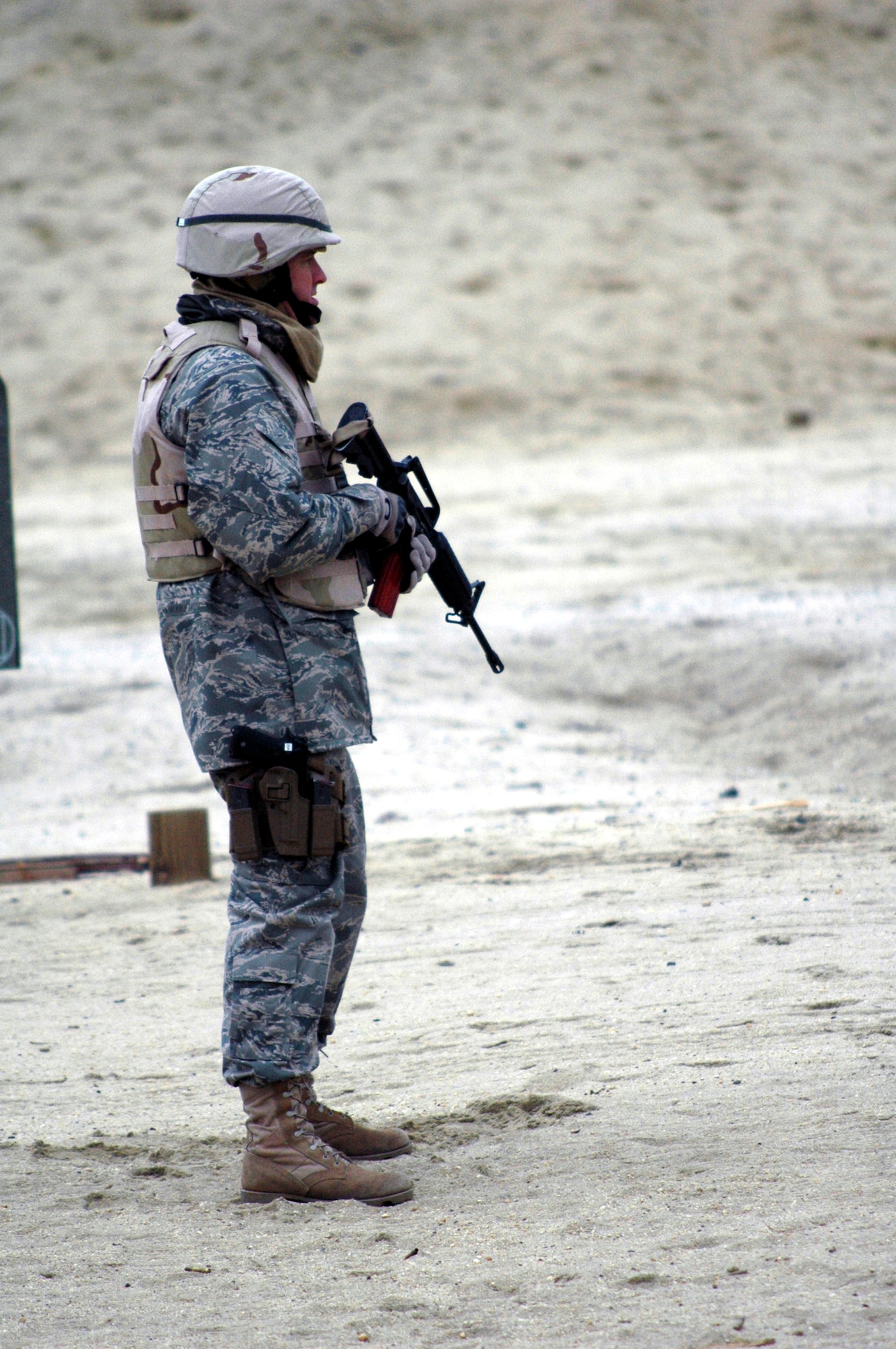 A student in the Air Advisor Course 08-1 waits for instructions to shoot during tactical live fire training with an M-4 and M-9 on a range on Fort Dix, N.J., Feb. 27, 2008.  The course is taught by the U.S. Air Force Expeditionary Center's Expeditionary Operations School and guest instructors preparing Airmen for upcoming deployments to Iraq and Afghanistan where they will train each country's forces. (U.S. Air Force Photo/Tech. Sgt. Scott T. Sturkol)