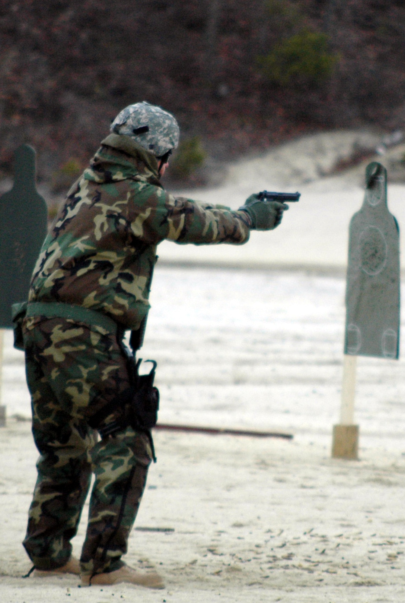A student in the Air Advisor Course 08-1 shoots during tactical live fire training with an M-4 and M-9 on a range on Fort Dix, N.J., Feb. 27, 2008.  The course is taught by the U.S. Air Force Expeditionary Center's Expeditionary Operations School and guest instructors preparing Airmen for upcoming deployments to Iraq and Afghanistan where they will train each country's forces. (U.S. Air Force Photo/Tech. Sgt. Scott T. Sturkol)