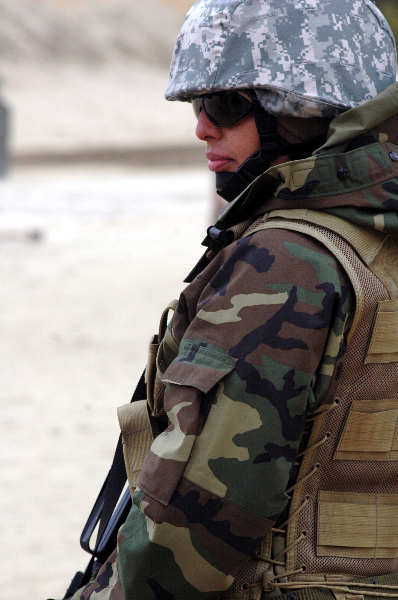SSgt. Itxel Goncalves waits for her next instructions to shoot during tactical live fire training with an M-4 and M-9 on a range on Fort Dix, N.J., Feb. 27, 2008, as part of training in the Air Advisor Course 08-1.  The course is taught by the U.S. Air Force Expeditionary Center's Expeditionary Operations School and guest instructors preparing Airmen for their roles in training forces in Afghanistan and Iraq.  Sergeant Goncalves is from the 320th Training Squadron, Lackland Air Force Base, Texas.  (U.S. Air Force Photo/Tech. Sgt. Scott T. Sturkol)