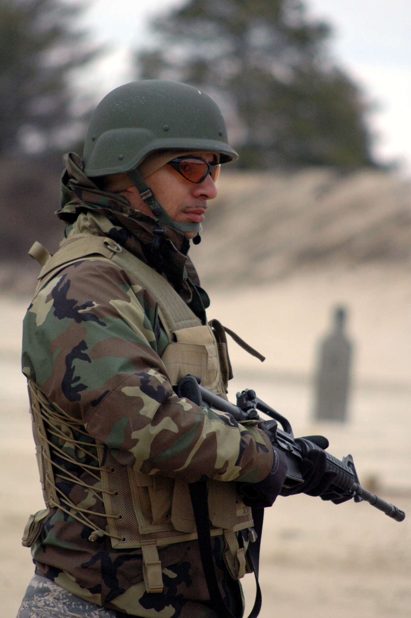 Staff Sgt. Saul Bookman waits for his next instructions to shoot during tactical live fire training with an M-4 and M-9 on a range on Fort Dix, N.J., Feb. 27, 2008, as part of training in the Air Advisor Course 08-1.  The course is taught by the U.S. Air Force Expeditionary Center's Expeditionary Operations School and guest instructors.  It's the first course of its kind at the Center preparing Airmen to go to Iraq and Afghanistan to train those countries' forces. Sergeant Bookman is from Lackland Air Force Base, Texas.  (U.S. Air Force Photo/Tech. Sgt. Scott T. Sturkol)