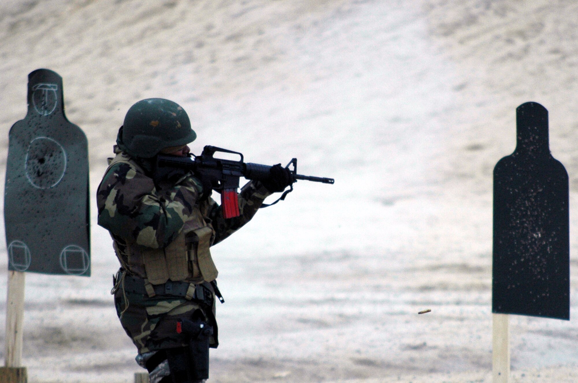 Staff Sgt. Tamica Harris shoots an M-4 during tactical live fire training with an M-4 and M-9 for the Air Advisor Course 08-1 on a range on Fort Dix, N.J., Feb. 27, 2008.  The course is taught by the U.S. Air Force Expeditionary Center's Expeditionary Operations School preparing Airmen for upcoming deployments to Iraq and Afghanistan where they will train those country's forces. Sergeant Harris is from the 319th Training Squadron, Lackland Air Force Base, Texas.  (U.S. Air Force Photo/Tech. Sgt. Scott T. Sturkol)