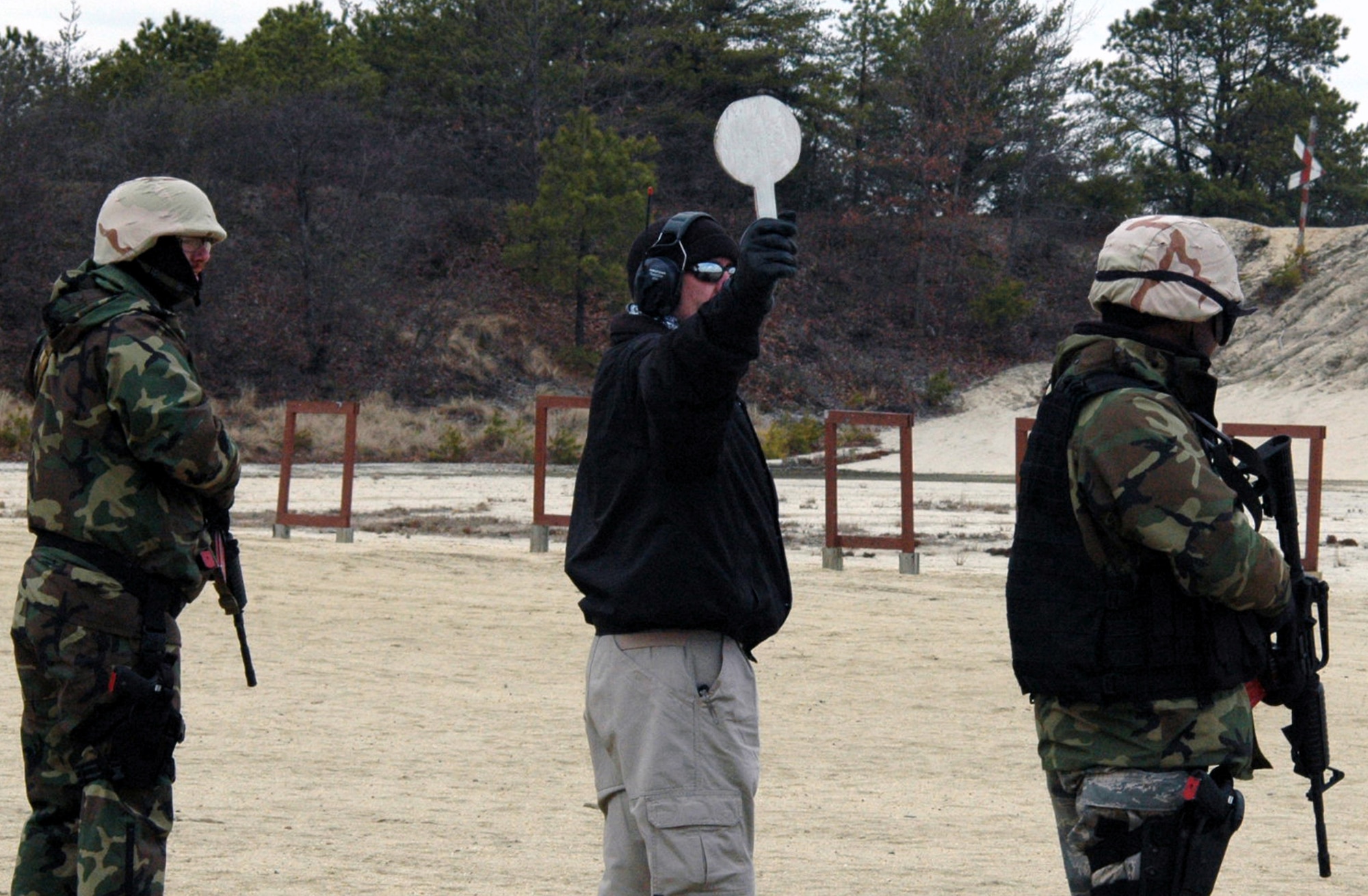 Students in the U.S. Air Force Expeditionary Center's Air Advisor Course 08-1 wait for instructions to shoot during tactical live fire training with an M-4 and M-9 on a range on Fort Dix, N.J., Feb. 27, 2008.  The course is taught by the Center's Expeditionary Operations School.  The students in the course will be  deploying in the near future to help train forces in both Afghanistan and Iraq.  (U.S. Air Force Photo/Tech. Sgt. Scott T. Sturkol)