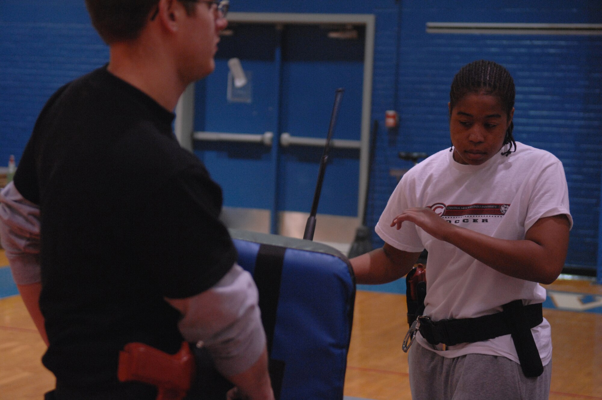 WHITEMAN AIR FORCE BASE, Mo-- Officer Lakeisha Carter, Chenega Company, practices the forward strike while Officer Matthew Gerhart, Chenega Company, holds the striking shield during a Self Defense class taught by civilian instructor Billy Matheny, 509th Security Forces, Feb. 20. This class is part of 70 hours of training that all new civilian security officers are required to have upon being hired. (U.S. Air Force photo/ Senior Airman Stephanie Clark)